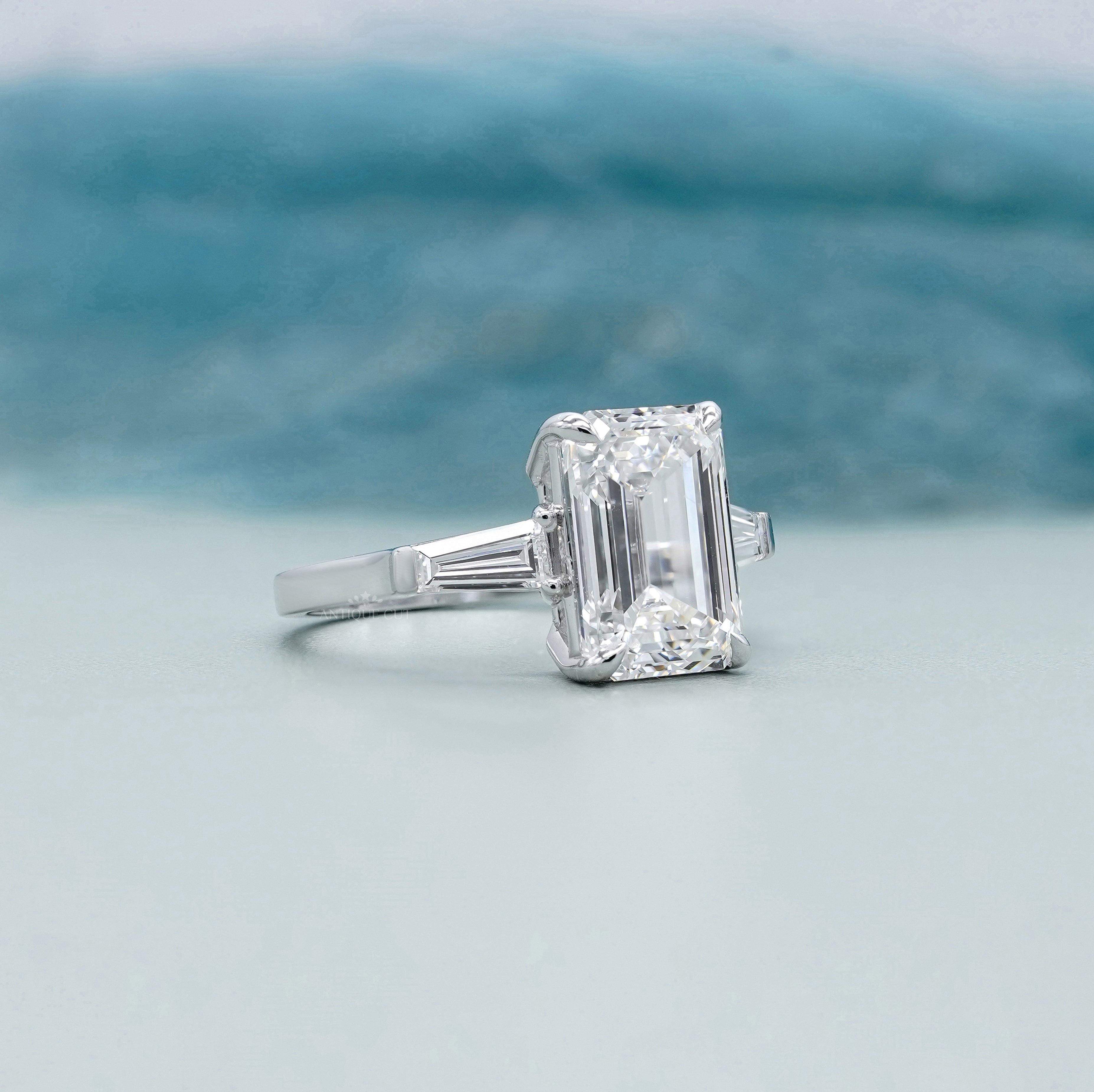 Emerald Cut 5.60tcw Lab Grown Diamond Three Stone Engagement Ring | Baguette Side Stones | Platinum/White Gold | IGI Certified