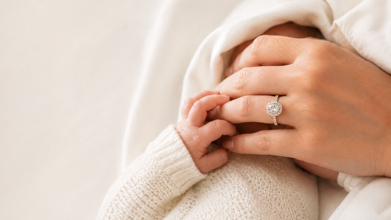 Mother and baby hands with diamond push present ring