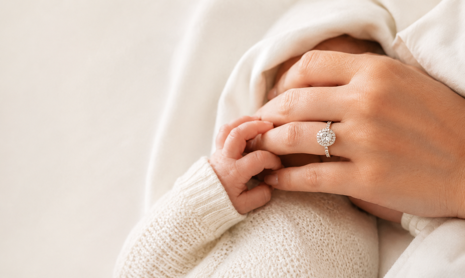 Mother and baby hands with diamond push present ring