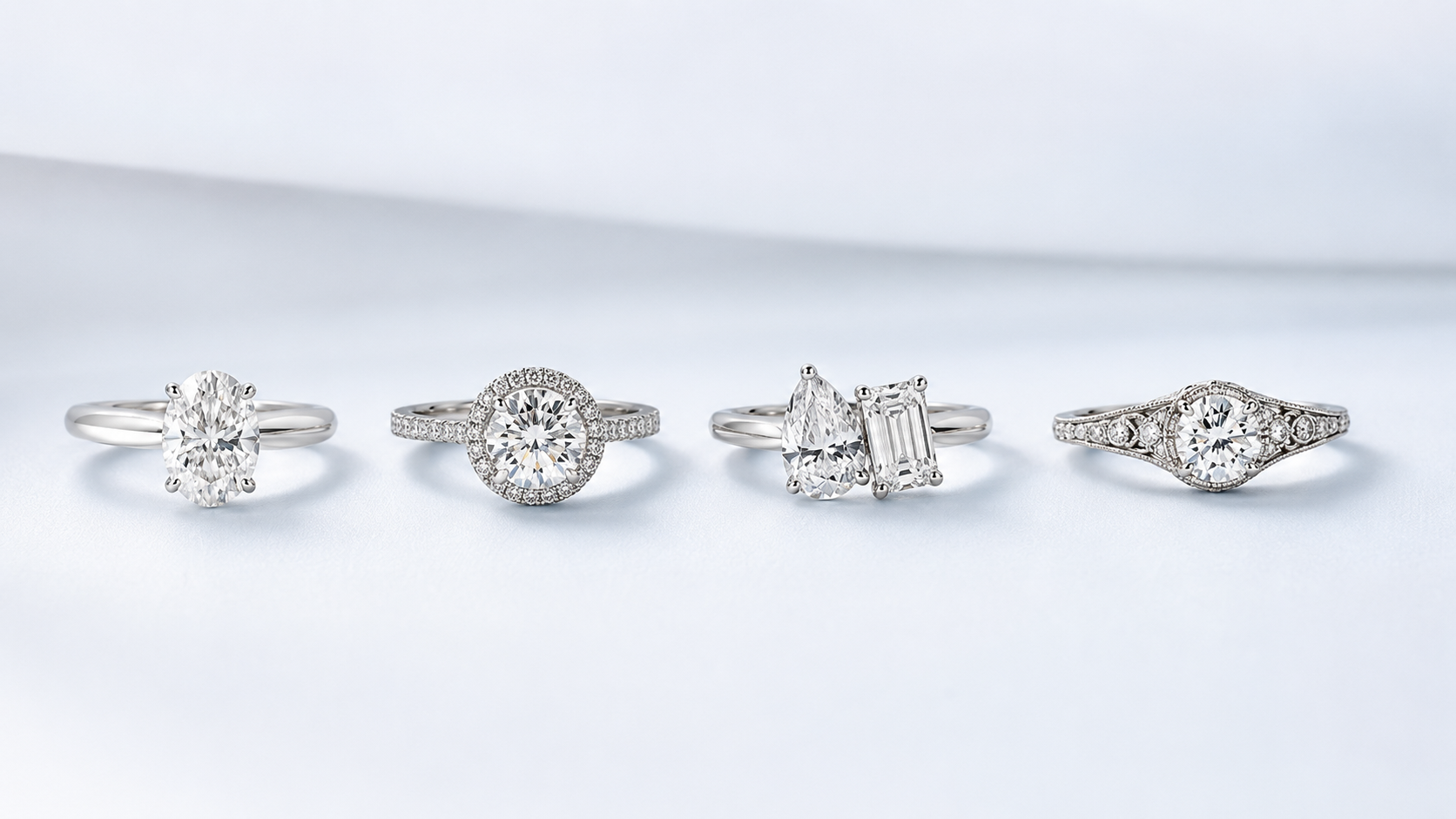 Four realistic diamond engagement rings on a soft white background