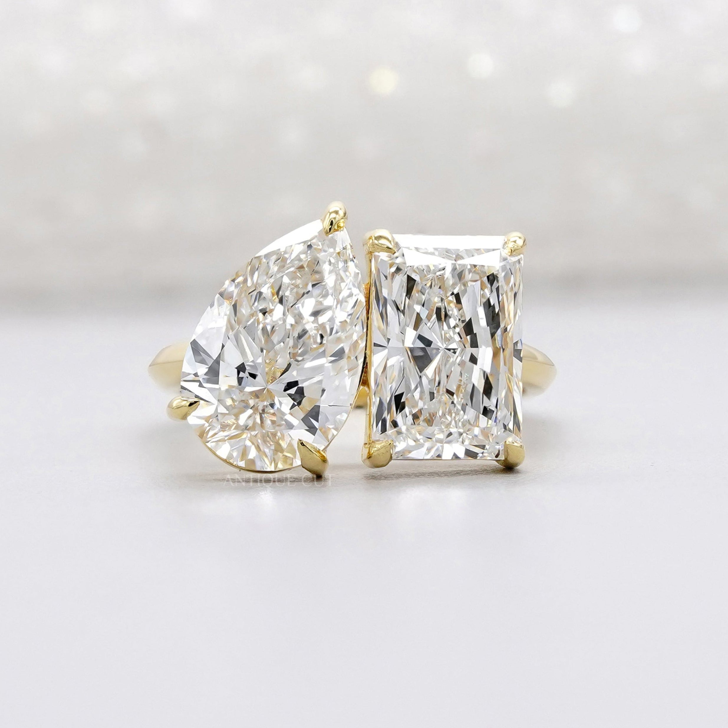 Two tone pear and radiant diamond ring in yellow gold