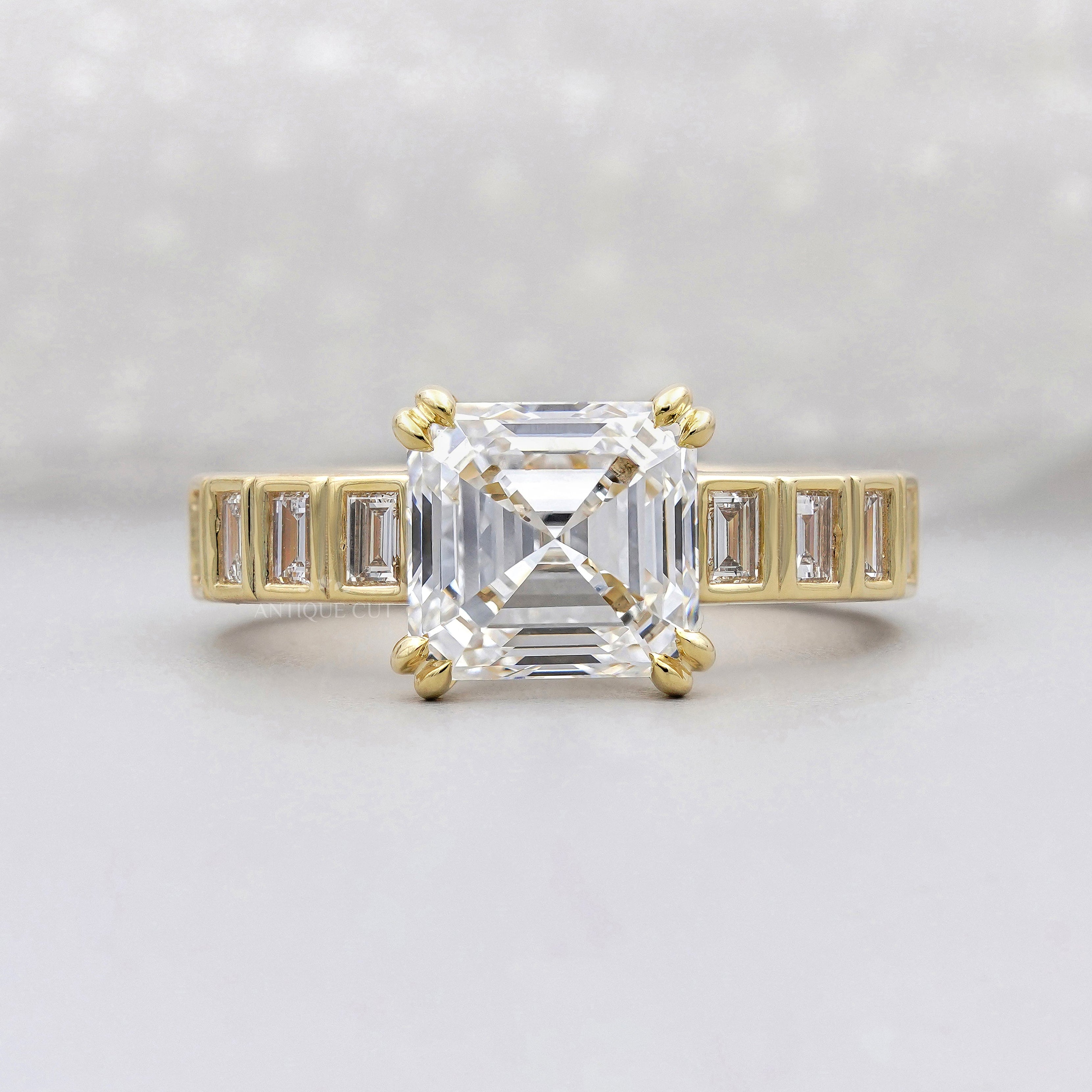 Asscher cut yellow gold engagement ring with baguette stones