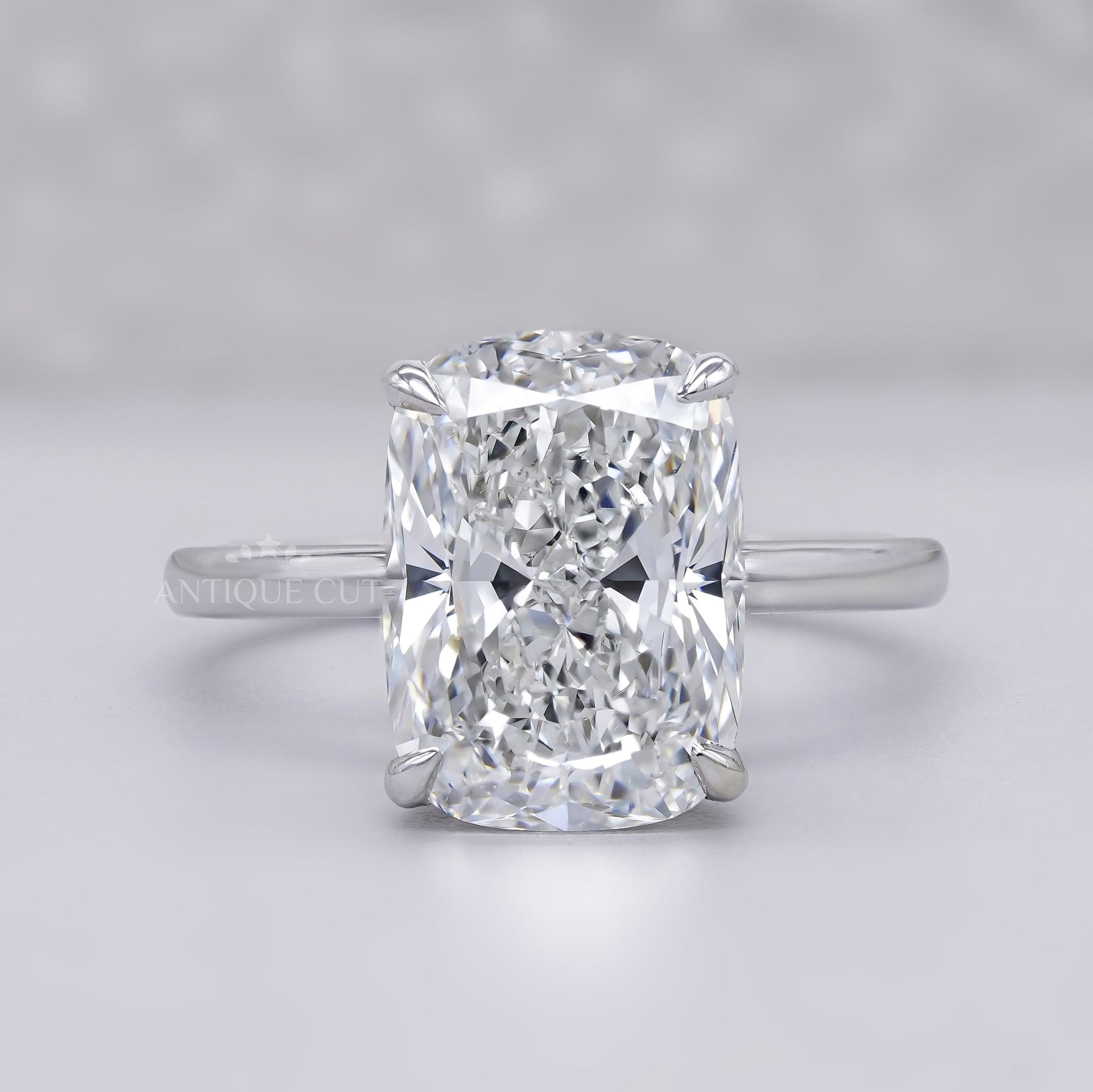 Elongated cushion cut solitaire engagement ring in white gold