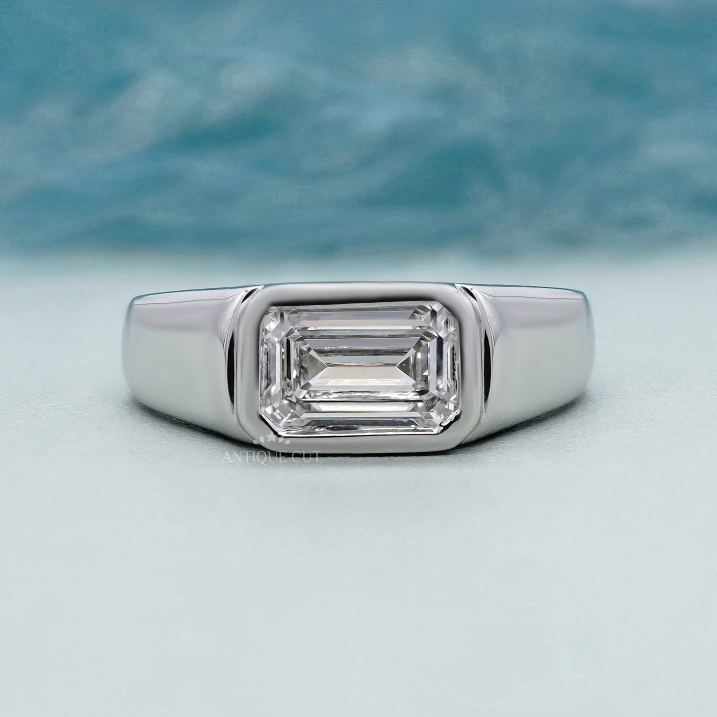 bezel set east west emerald cut diamond ring in white gold
