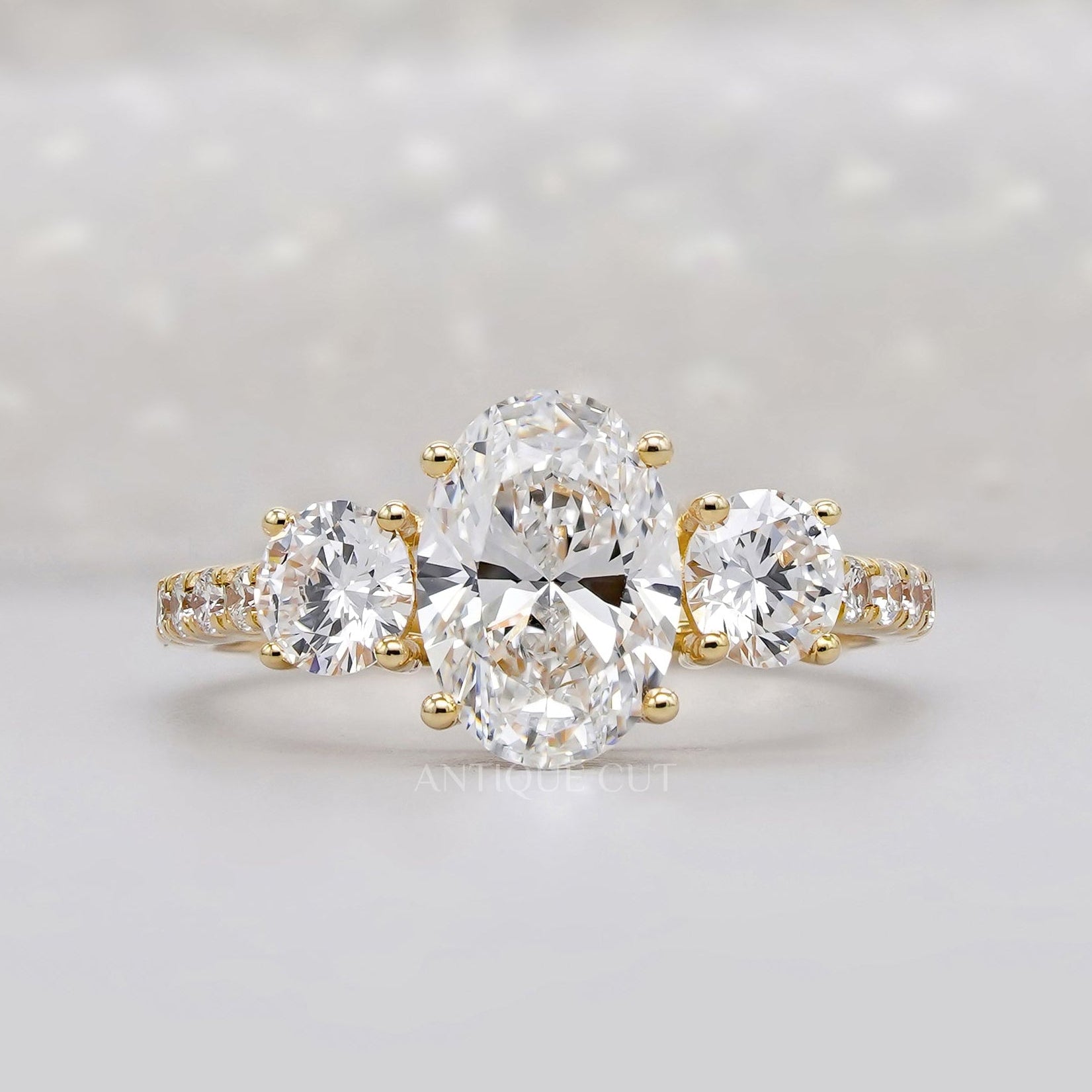 Three stone oval engagement ring in yellow gold