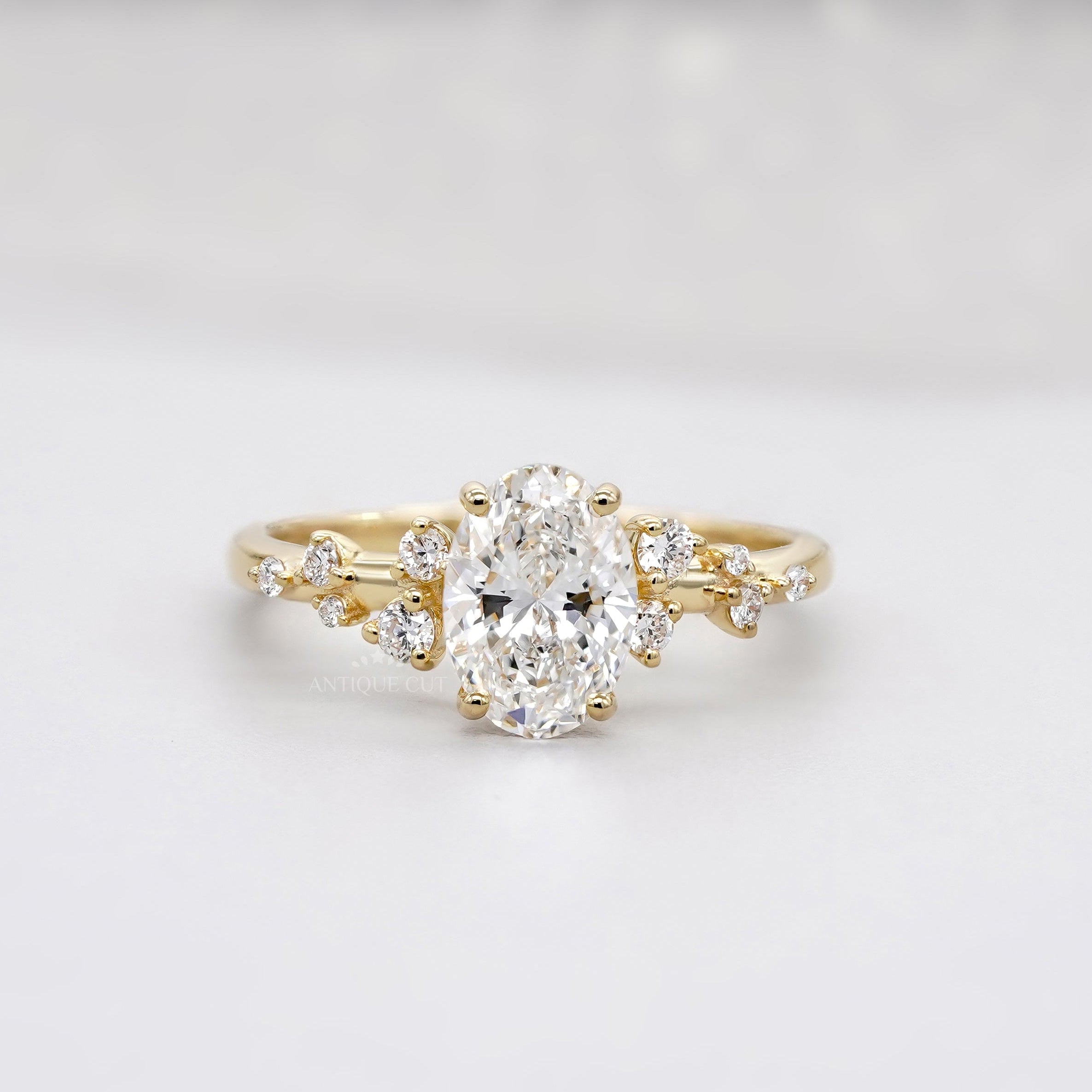 Oval shaped engagement ring with vintage diamond cluster design