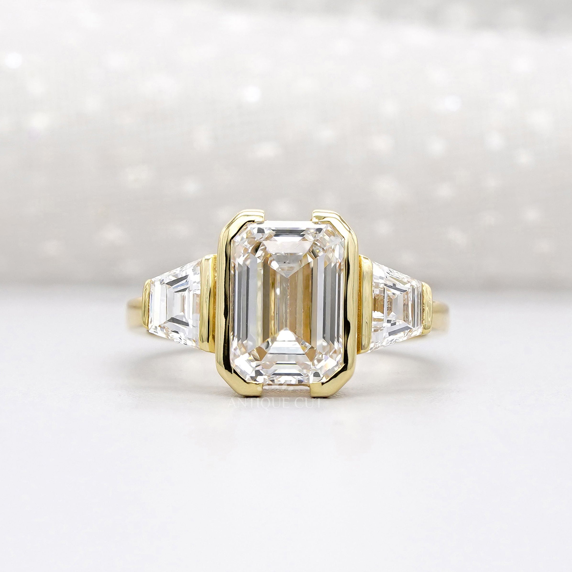 Emerald cut diamond engagement ring bezel set yellow gold