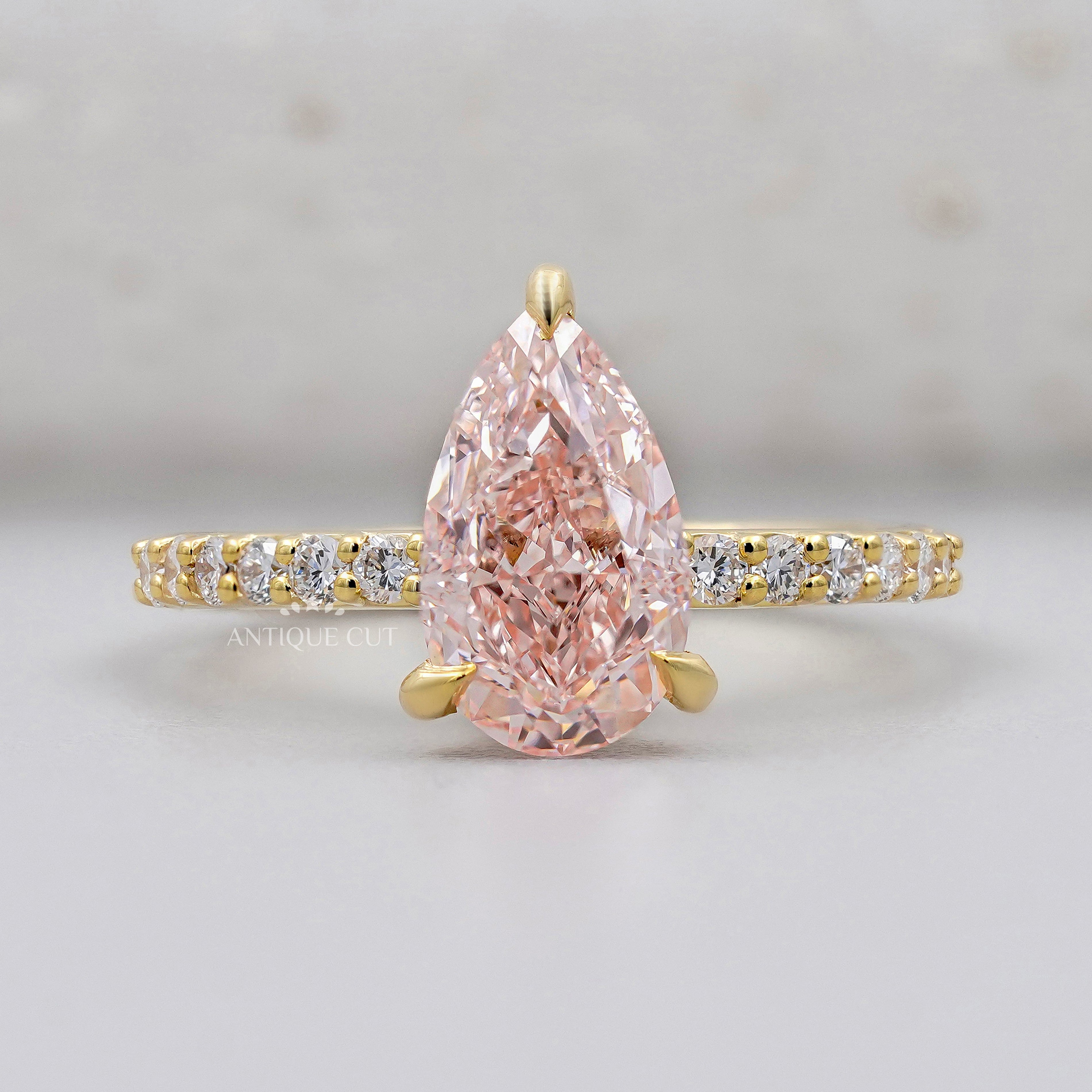 Pear fancy pink diamond ring with pavé band in yellow gold