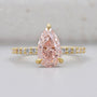 Pear fancy pink diamond ring with pavé band in yellow gold