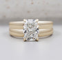 Radiant cut diamond engagement ring with wide yellow gold band and four prong setting