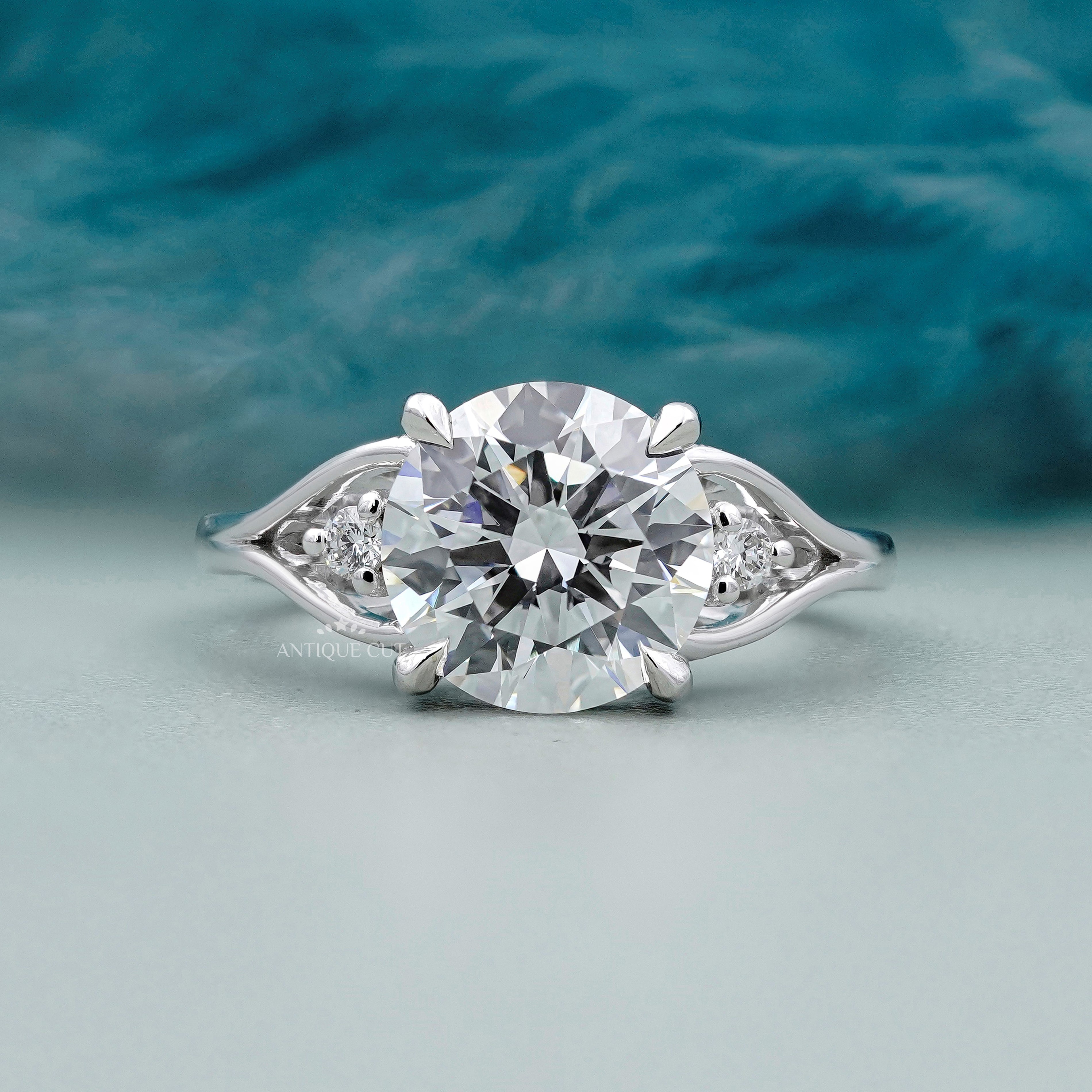 Round cut diamond engagement ring with side stones in white gold