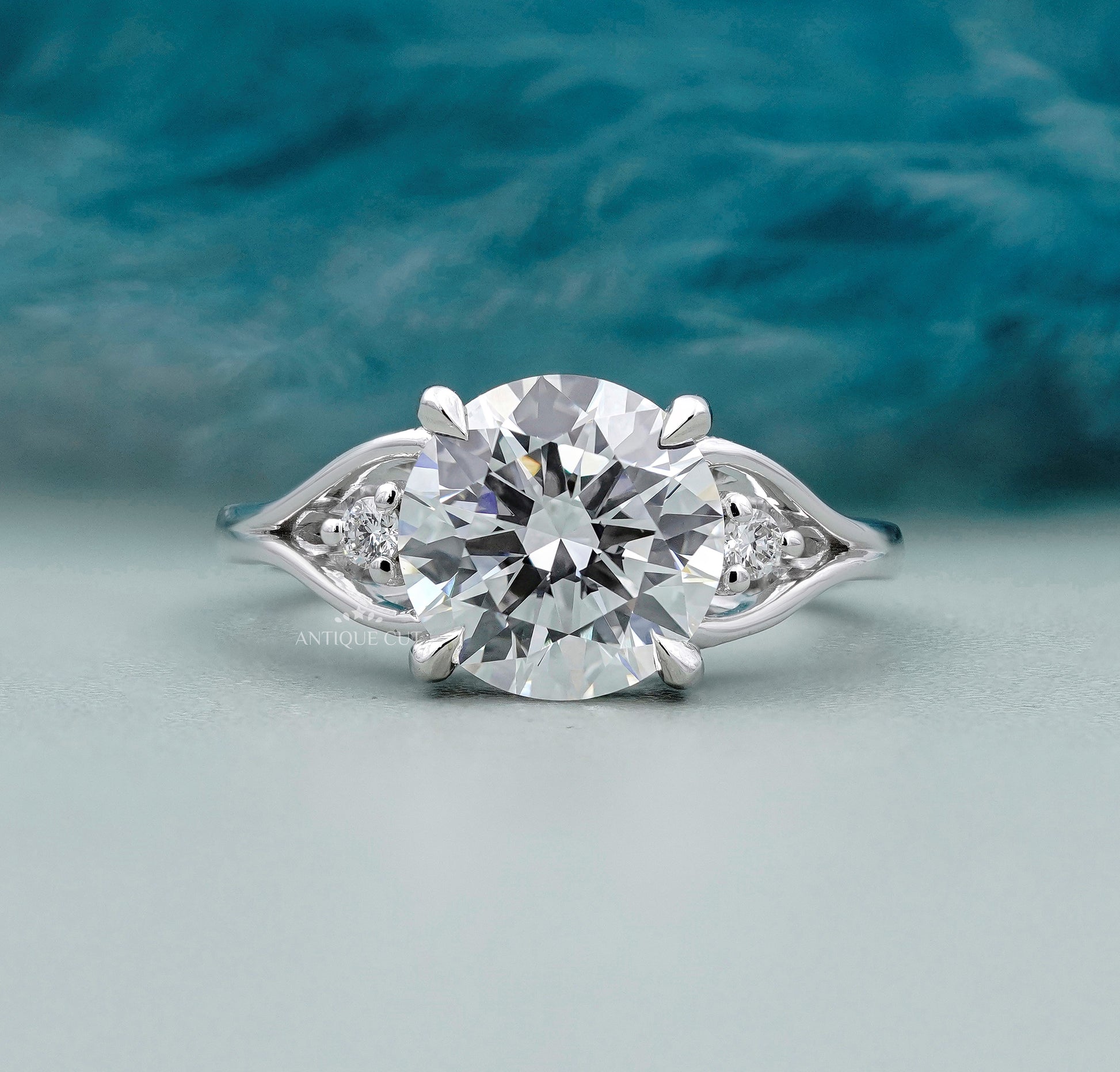 Round cut diamond engagement ring with side stones in white gold