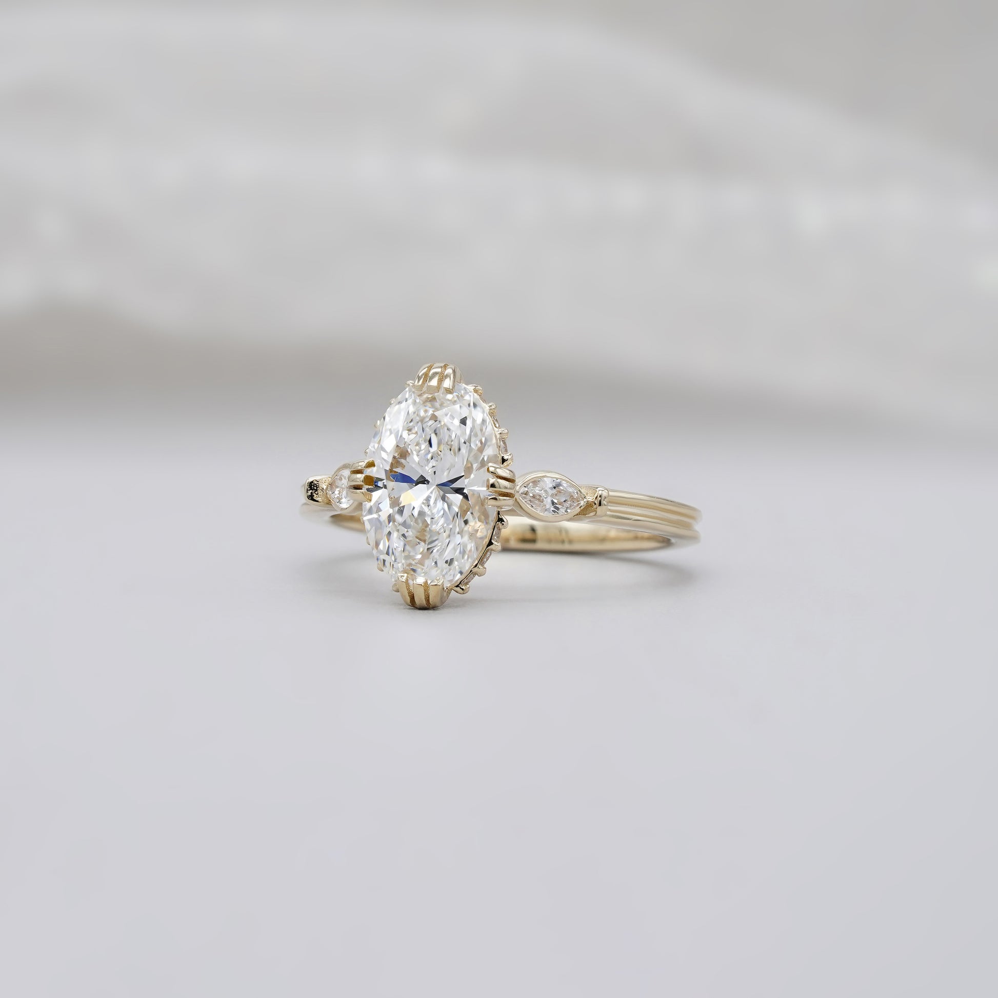 Three stone diamond ring with hidden halo