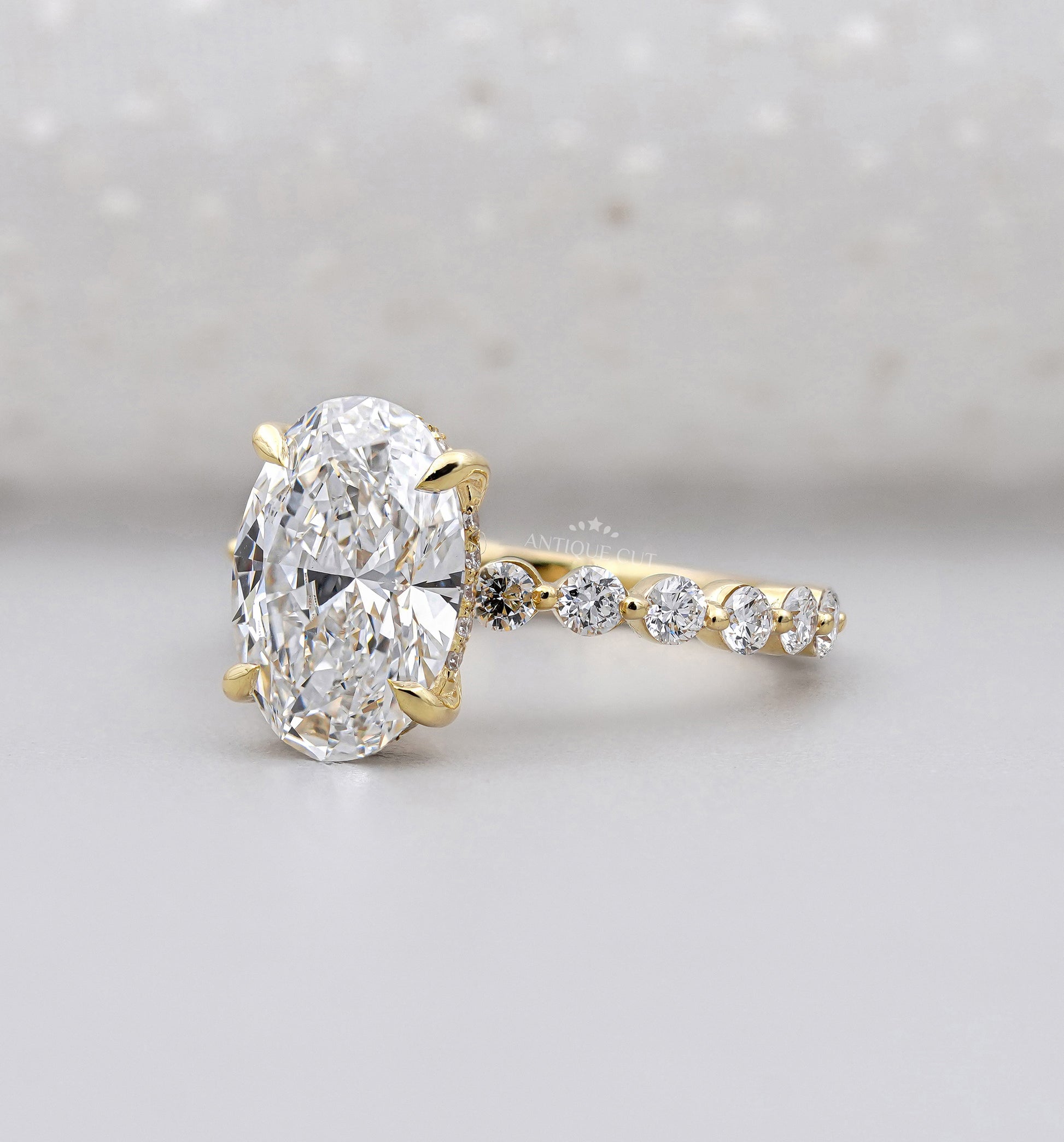 Hidden halo oval diamond engagement ring by Antiquecut
