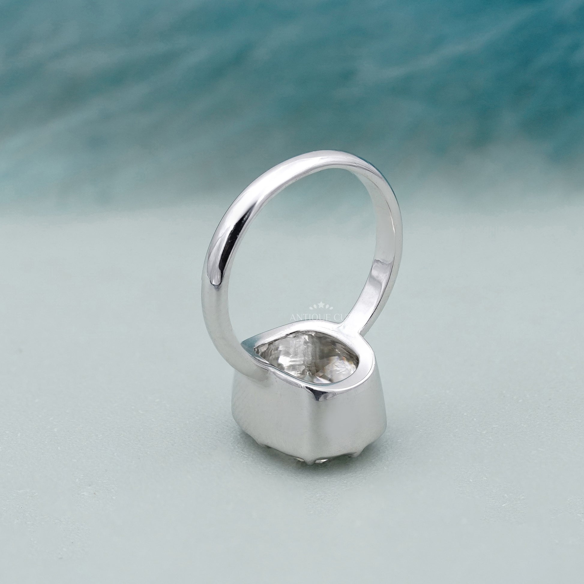 Lab grown elongated cushion solitaire ring with bezel setting
