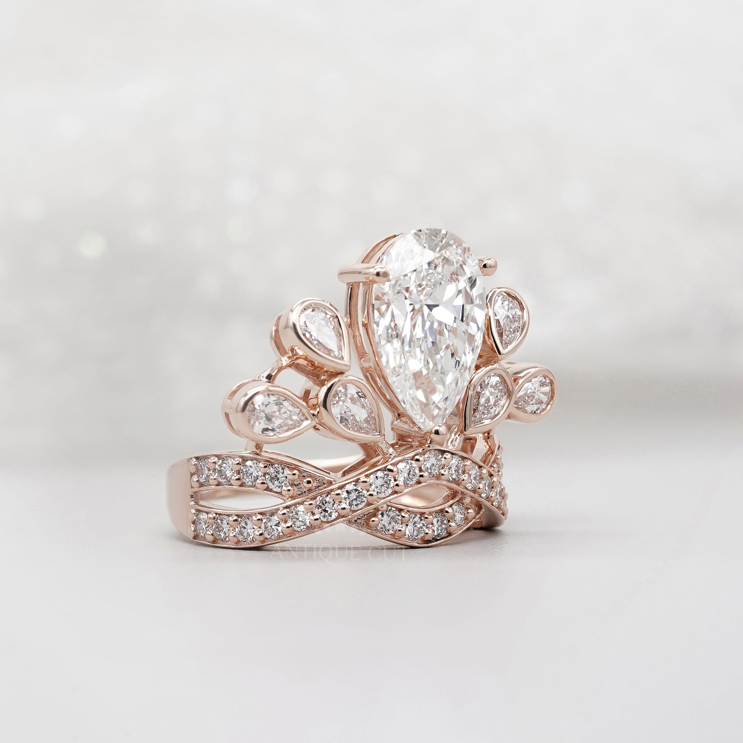 Rose gold pear diamond ring with side stones