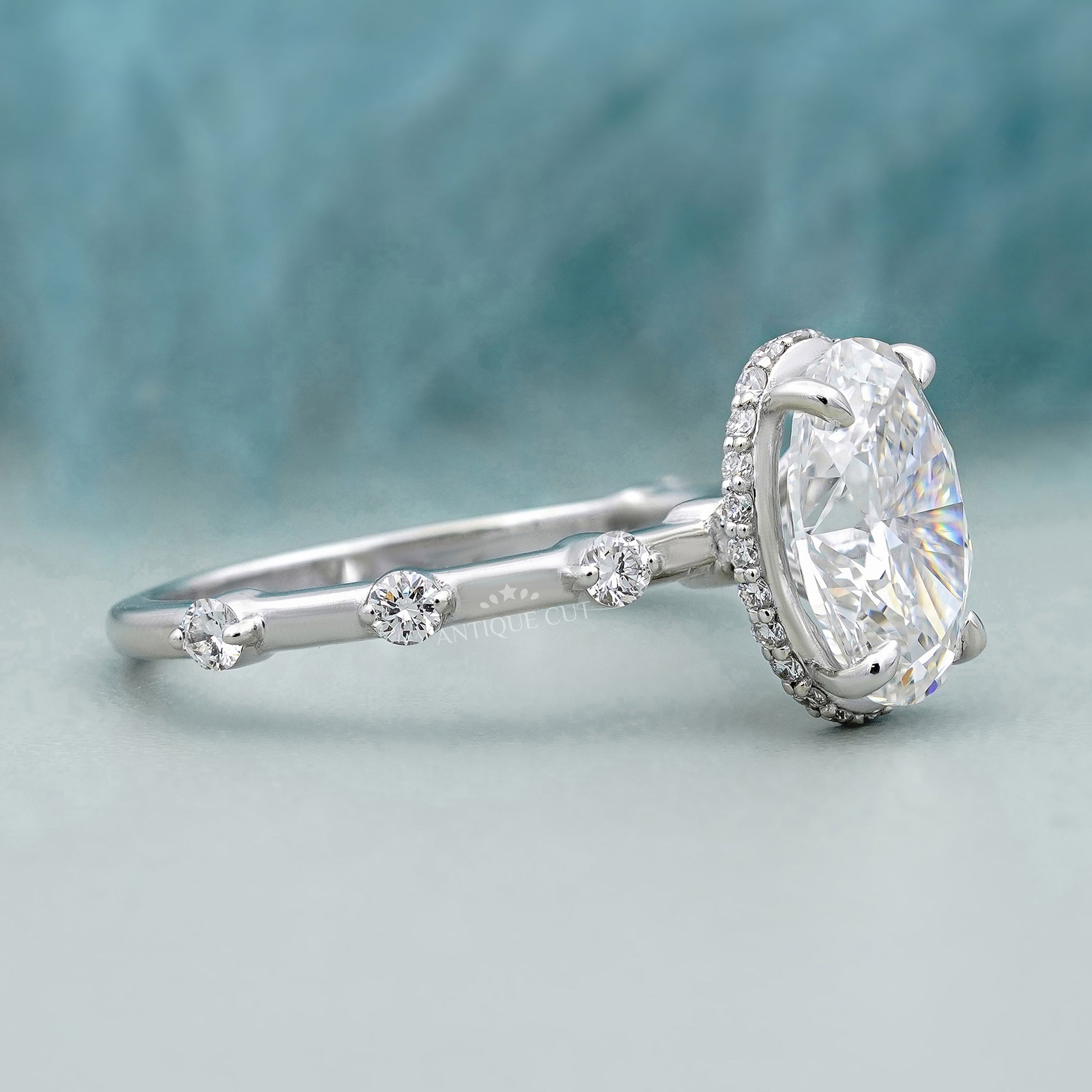 White gold oval cut diamond ring with sparkling accent band