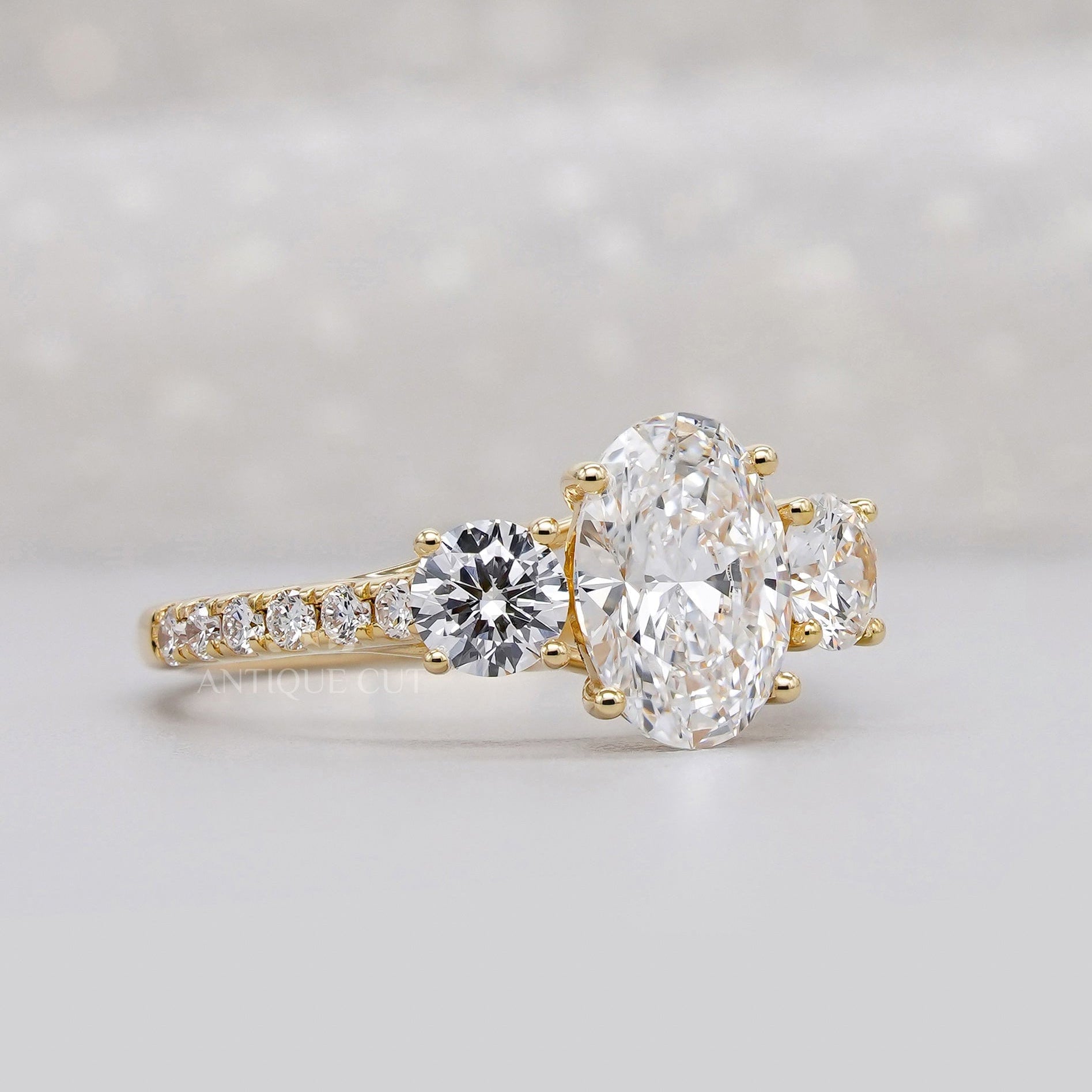Oval diamond three stone engagement ring