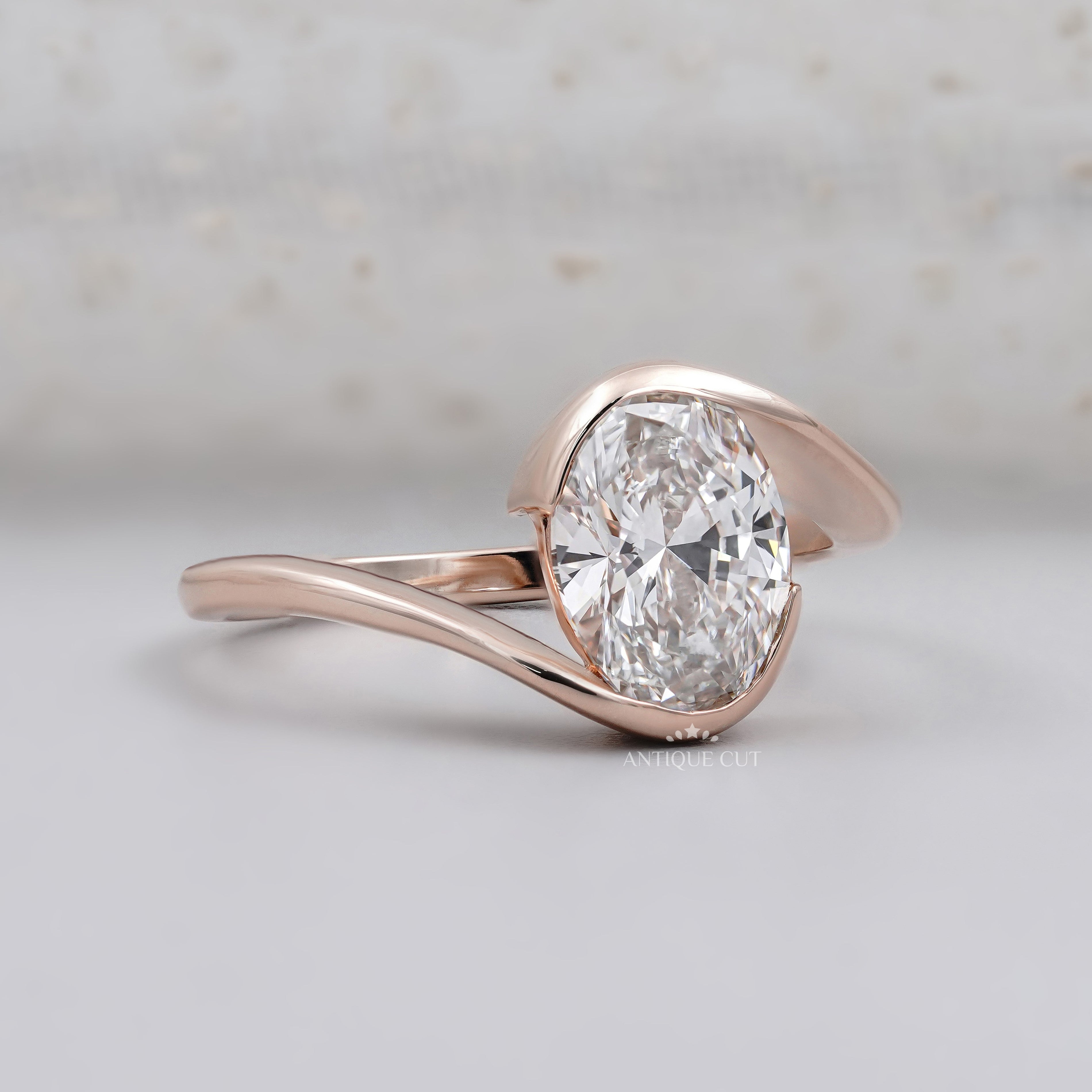 Oval cut diamond engagement ring with sculpted rose gold setting