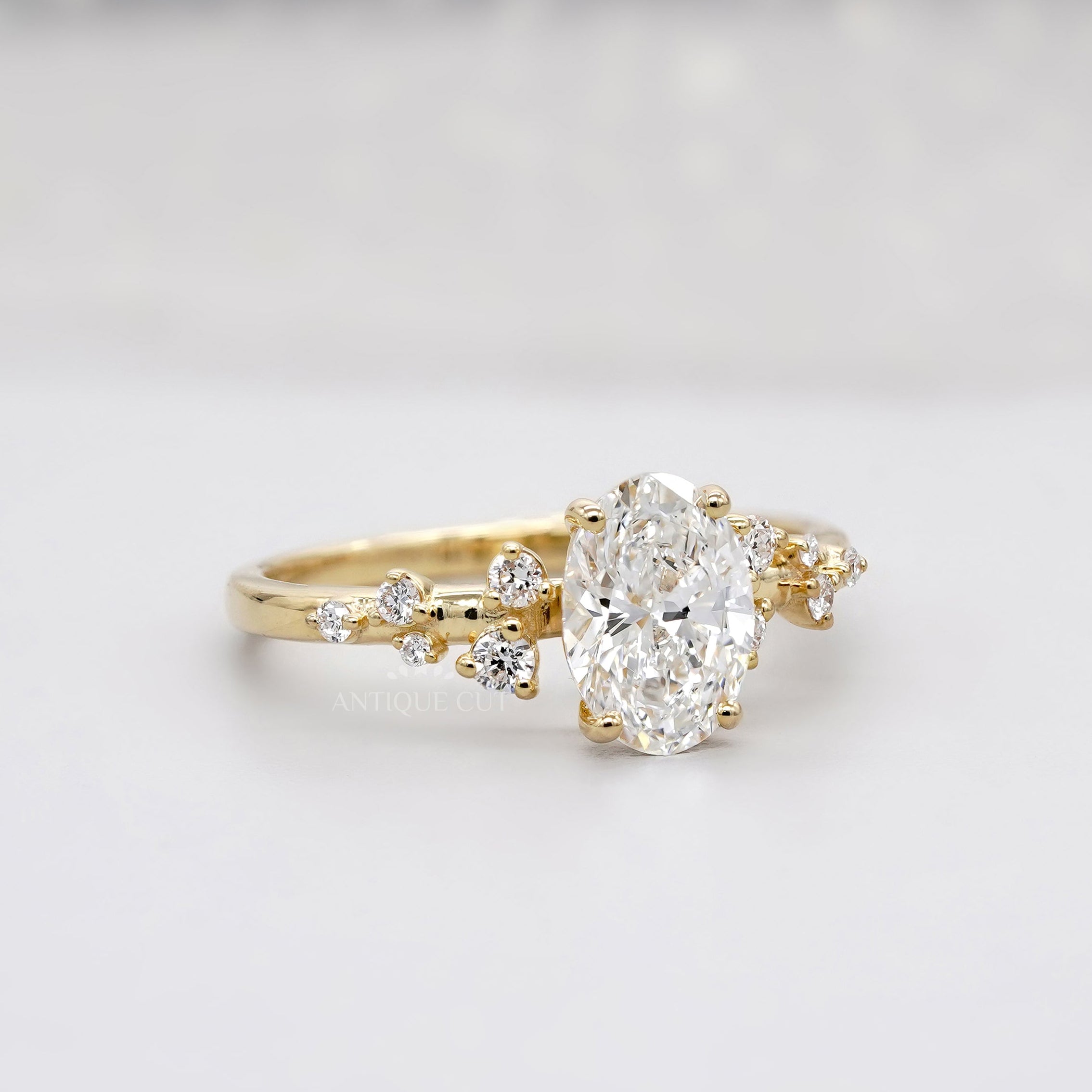 Oval engagement ring with lab grown diamond cluster