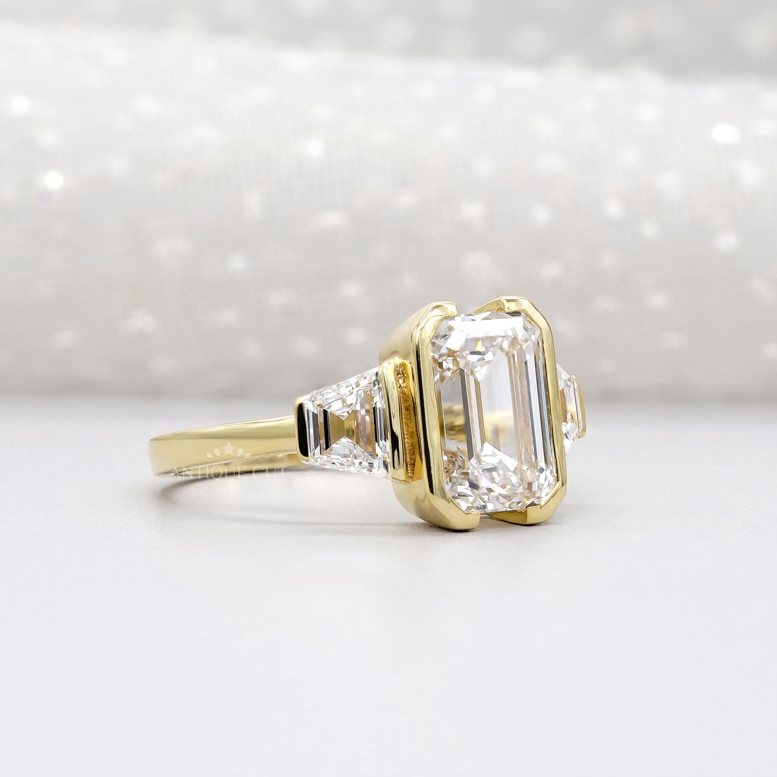Yellow gold emerald cut engagement ring with side stones