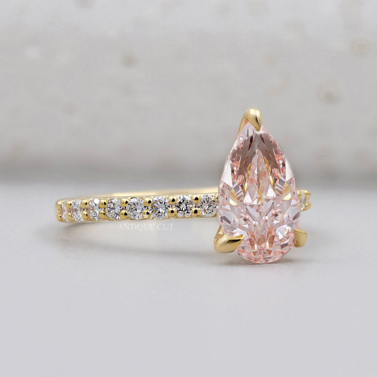 Lab grown pink pear diamond engagement ring with pavé band