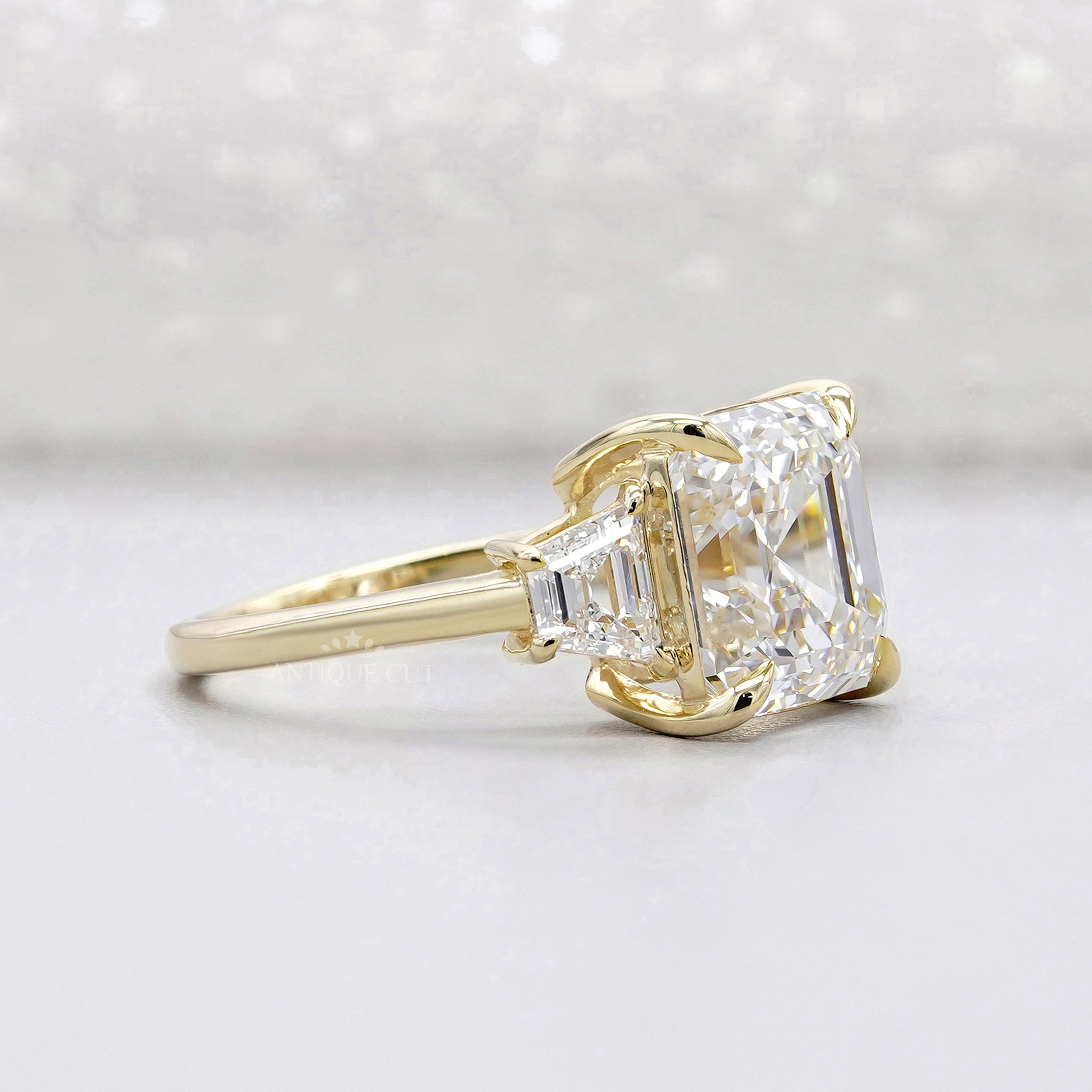 Yellow gold Asscher diamond ring with trapezoid accents