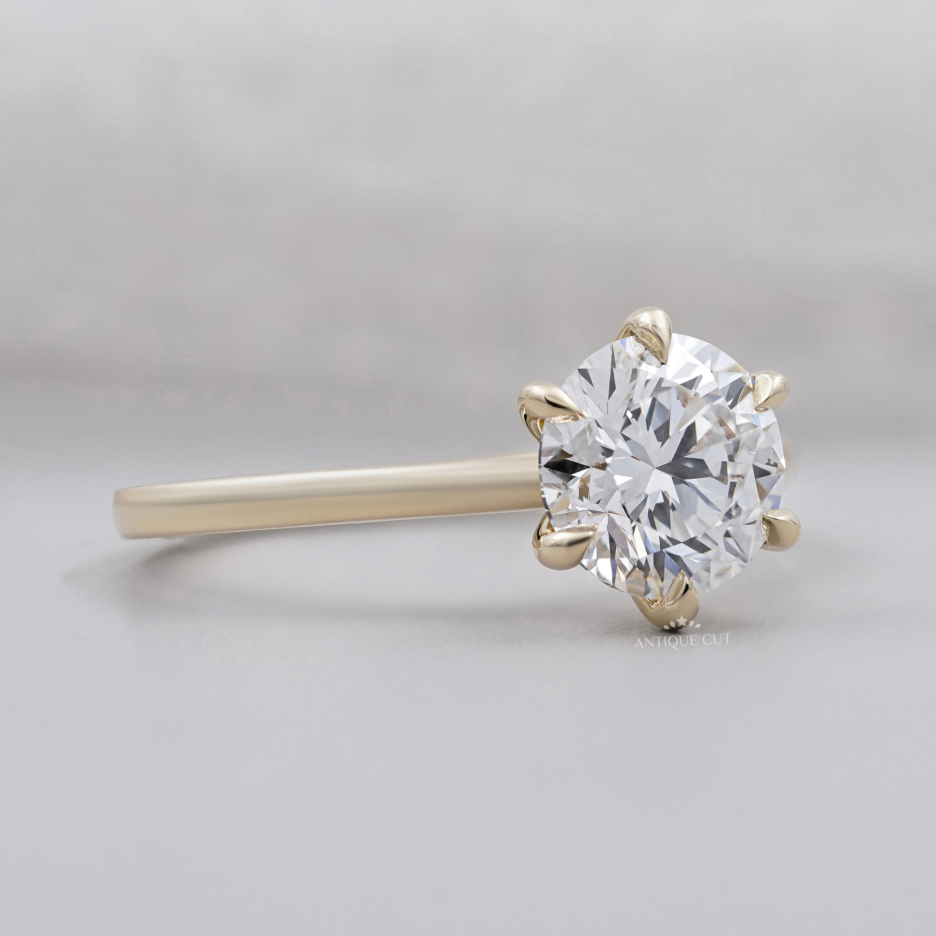 Yellow gold solitaire engagement ring with round center diamond