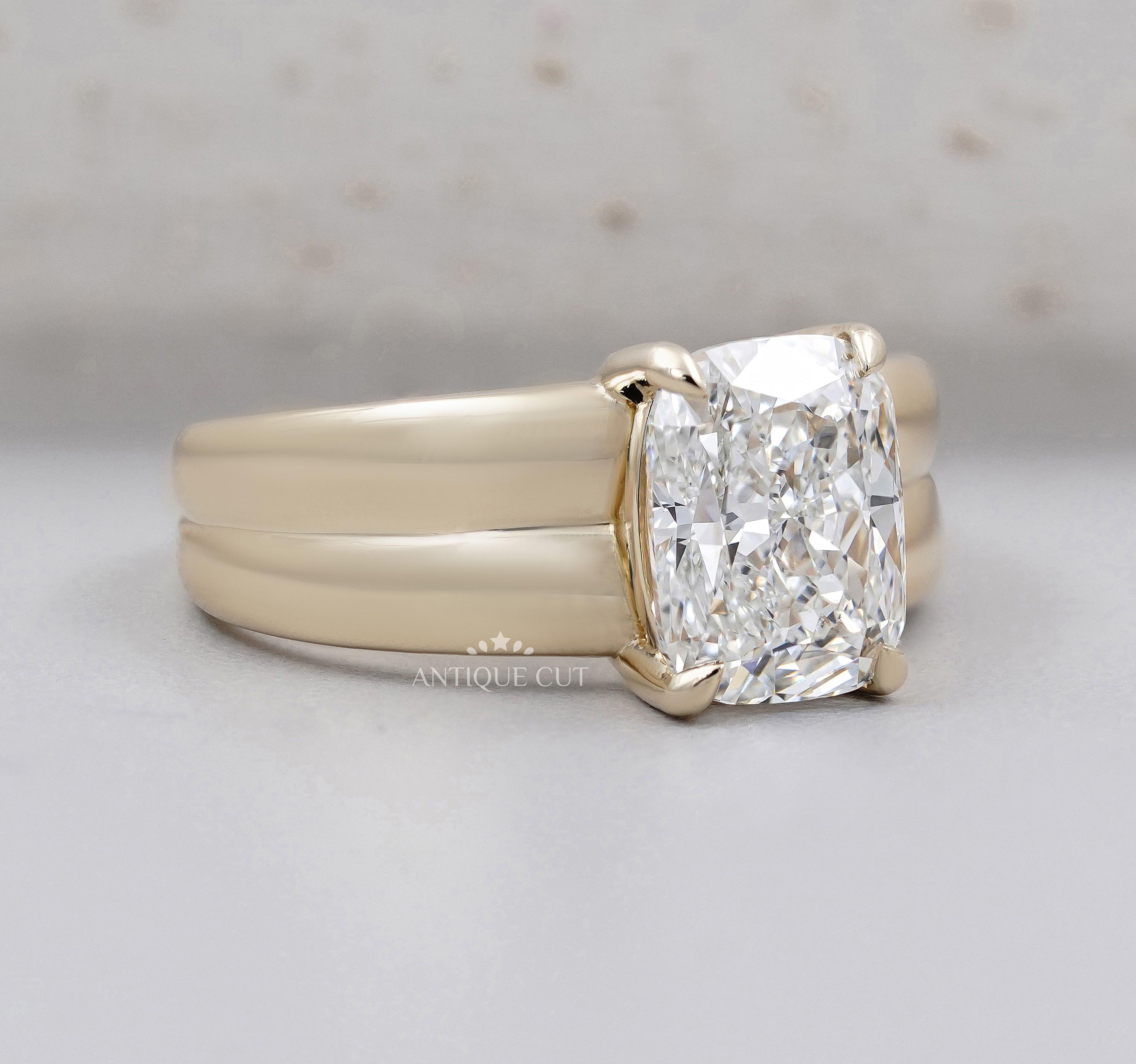 Yellow gold radiant diamond ring with bold double band design