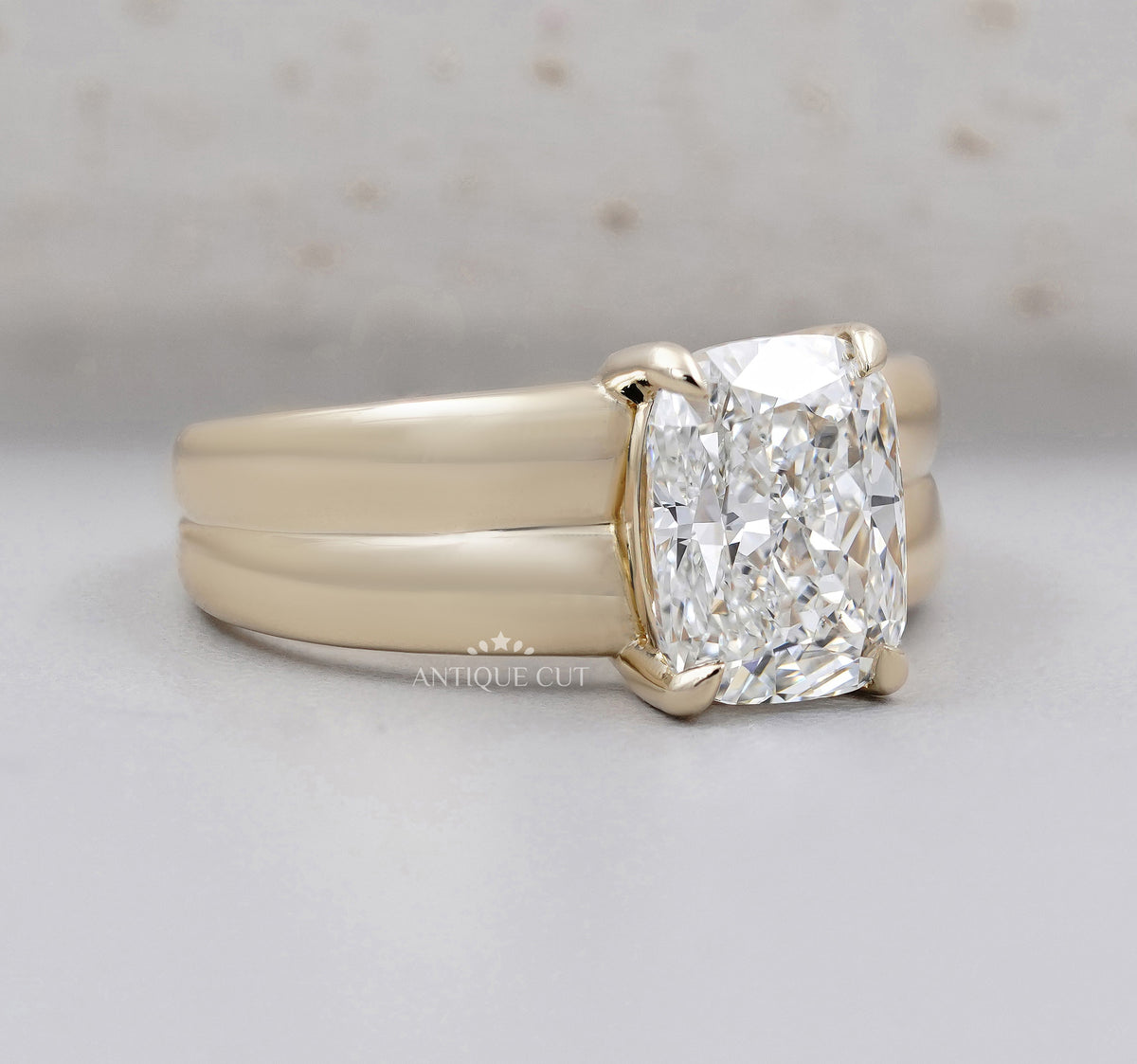 Yellow gold radiant diamond ring with bold double band design