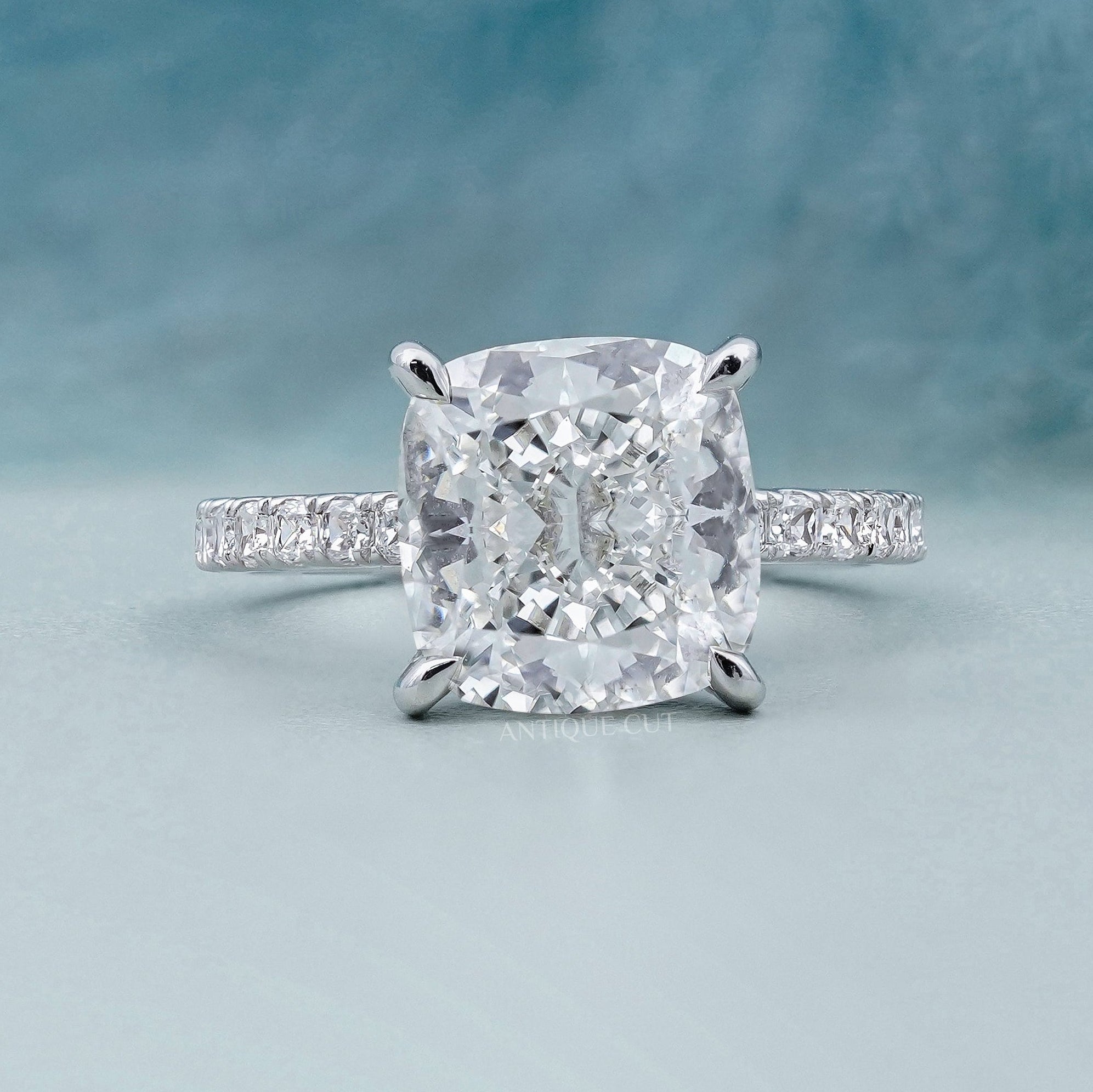 Cushion cut hidden halo engagement ring in white gold
