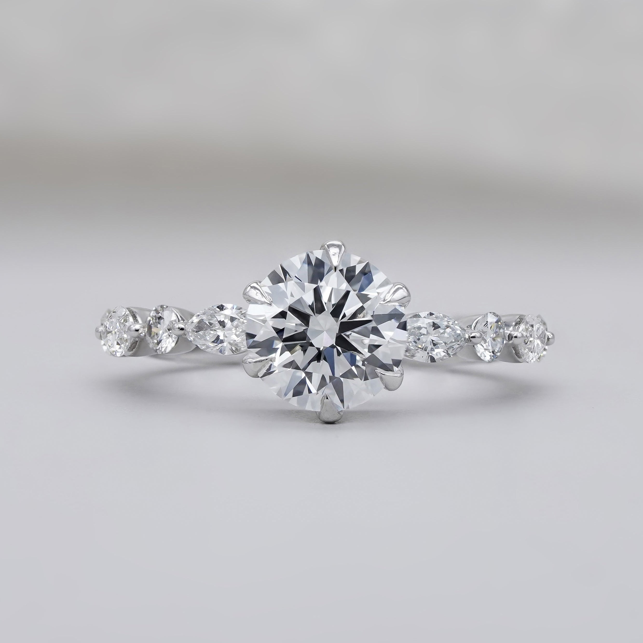 Round cut diamond ring with pave diamond band