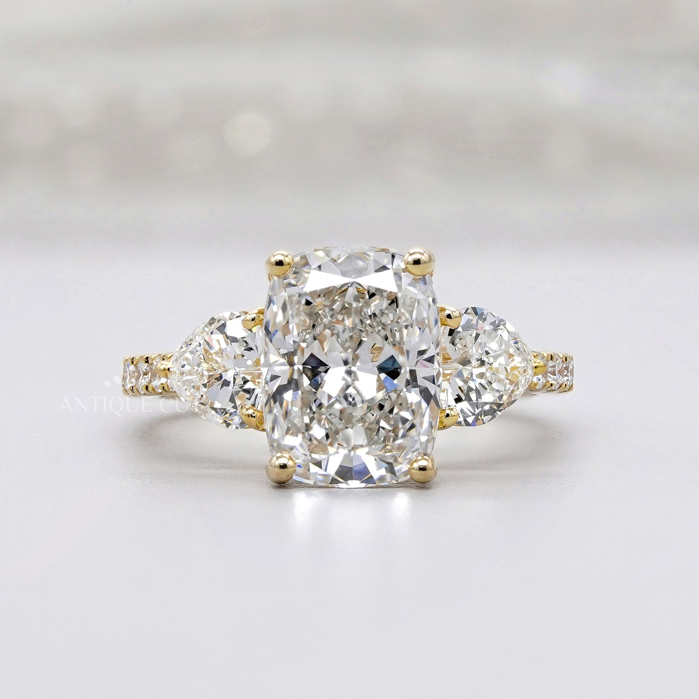 Three stone cushion cut engagement ring pave band
