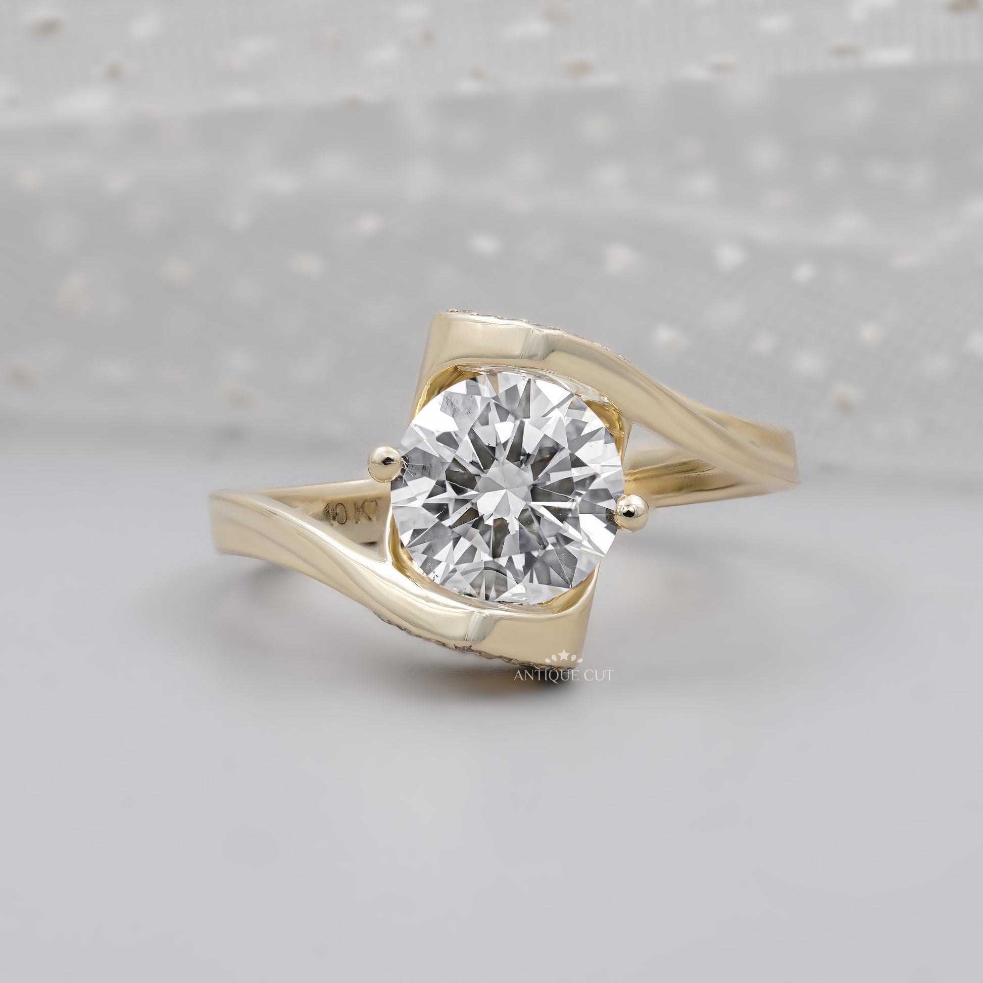 Round cut lab grown diamond engagement ring in yellow gold bypass setting