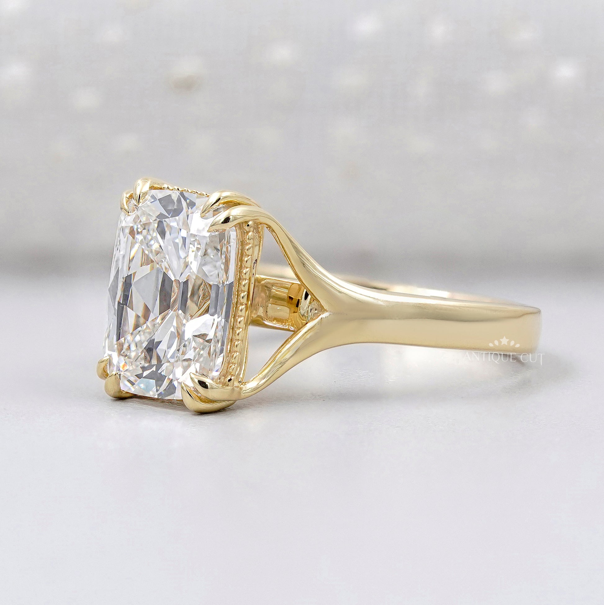 Yellow gold engagement ring with radiant cut center diamond