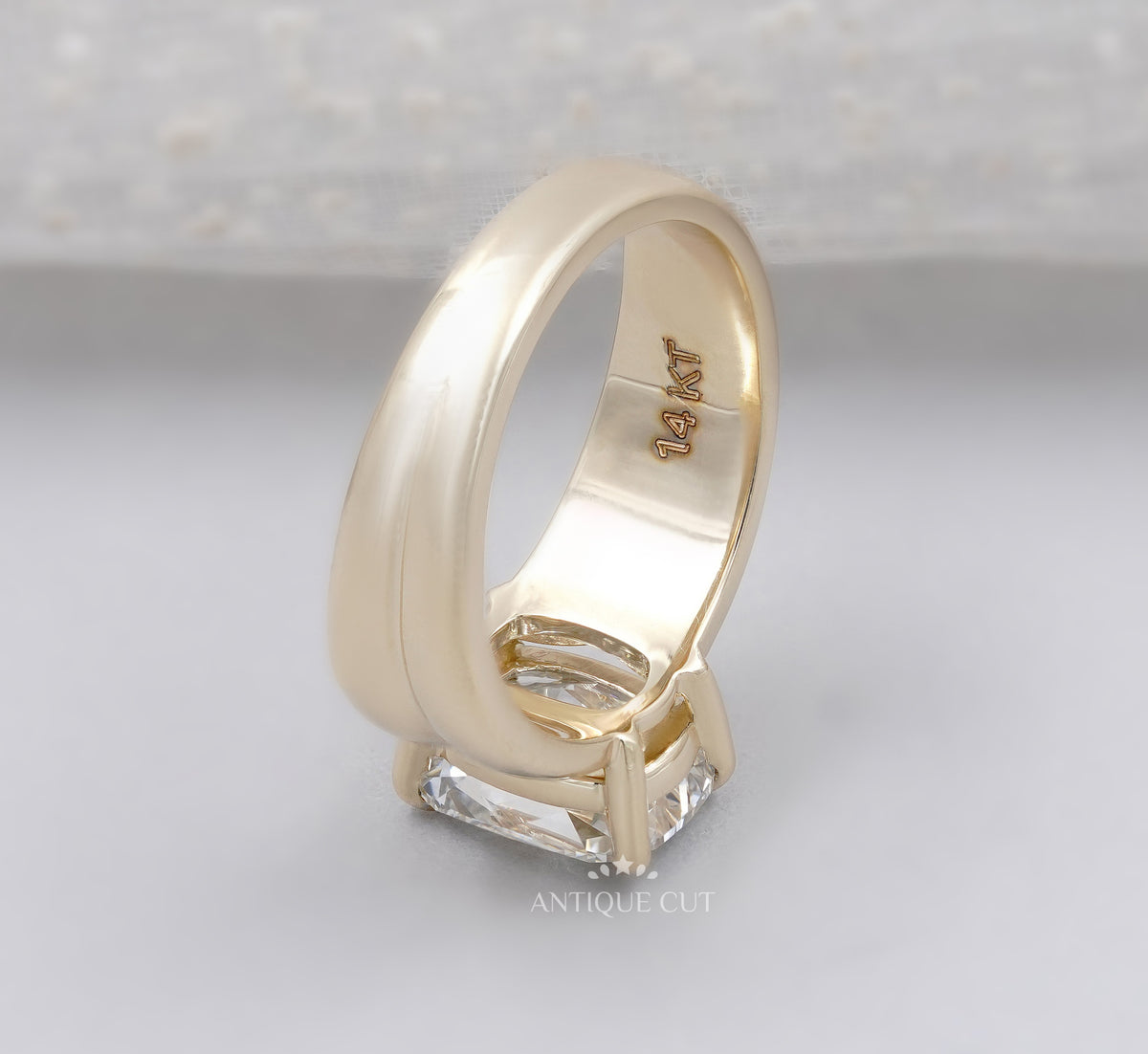 Yellow gold engagement ring featuring an elongated radiant cut center diamond