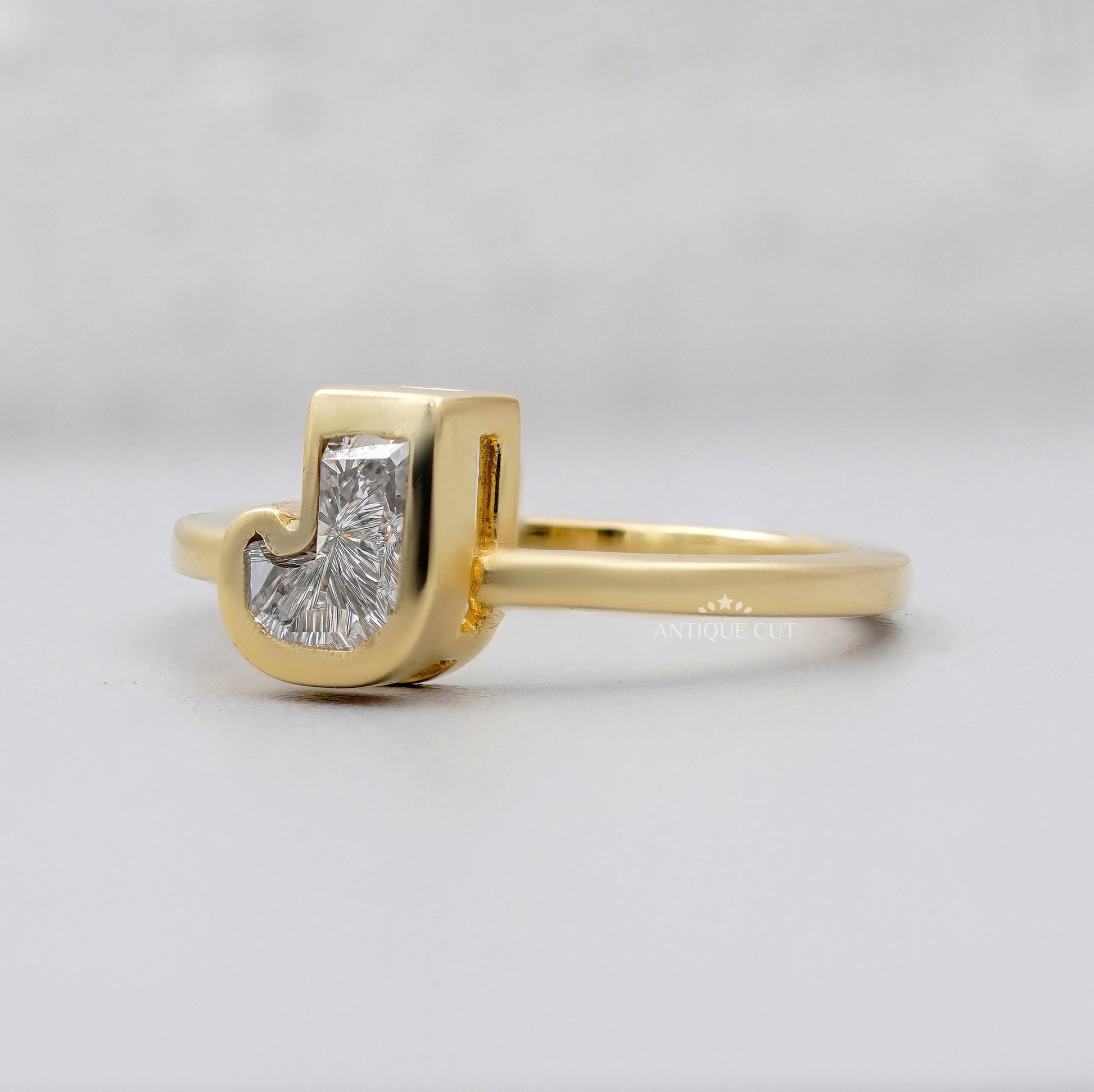 J letter diamond ring in yellow gold with secure bezel setting by Antiquecut