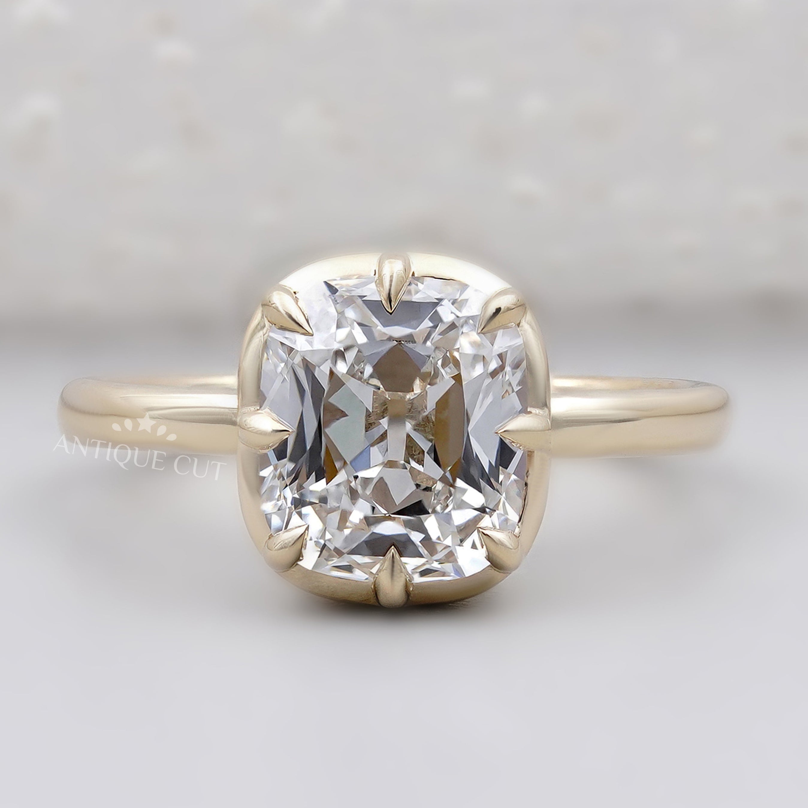 Old mine cushion cut engagement ring in yellow gold