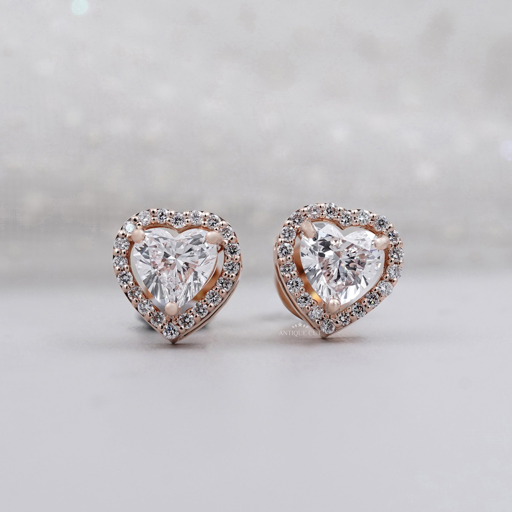 Close up of heart diamond stud earrings in rose gold