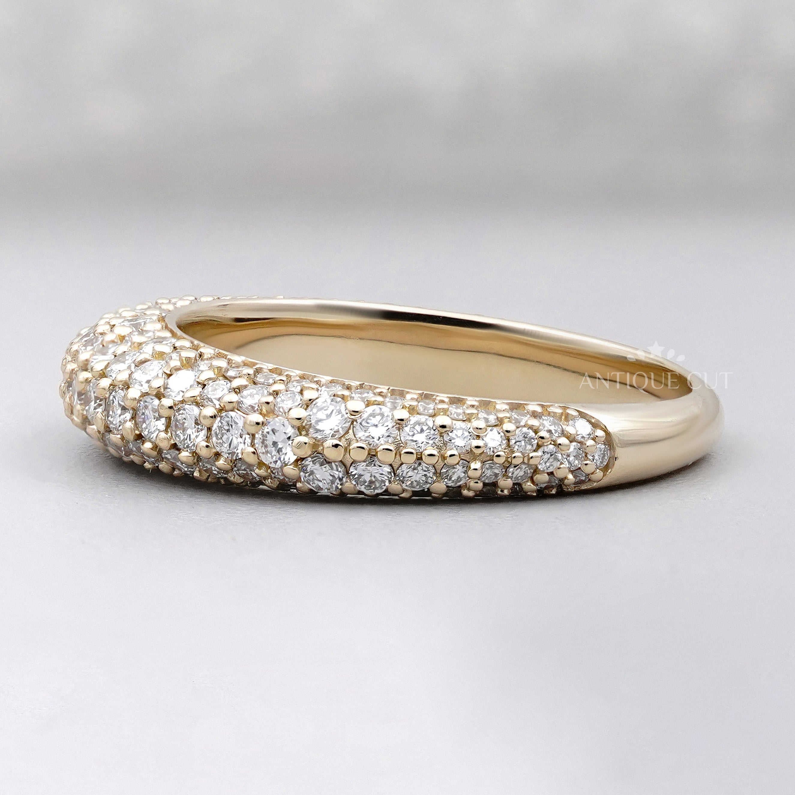 yellow gold diamond eternity band featuring a pave setting