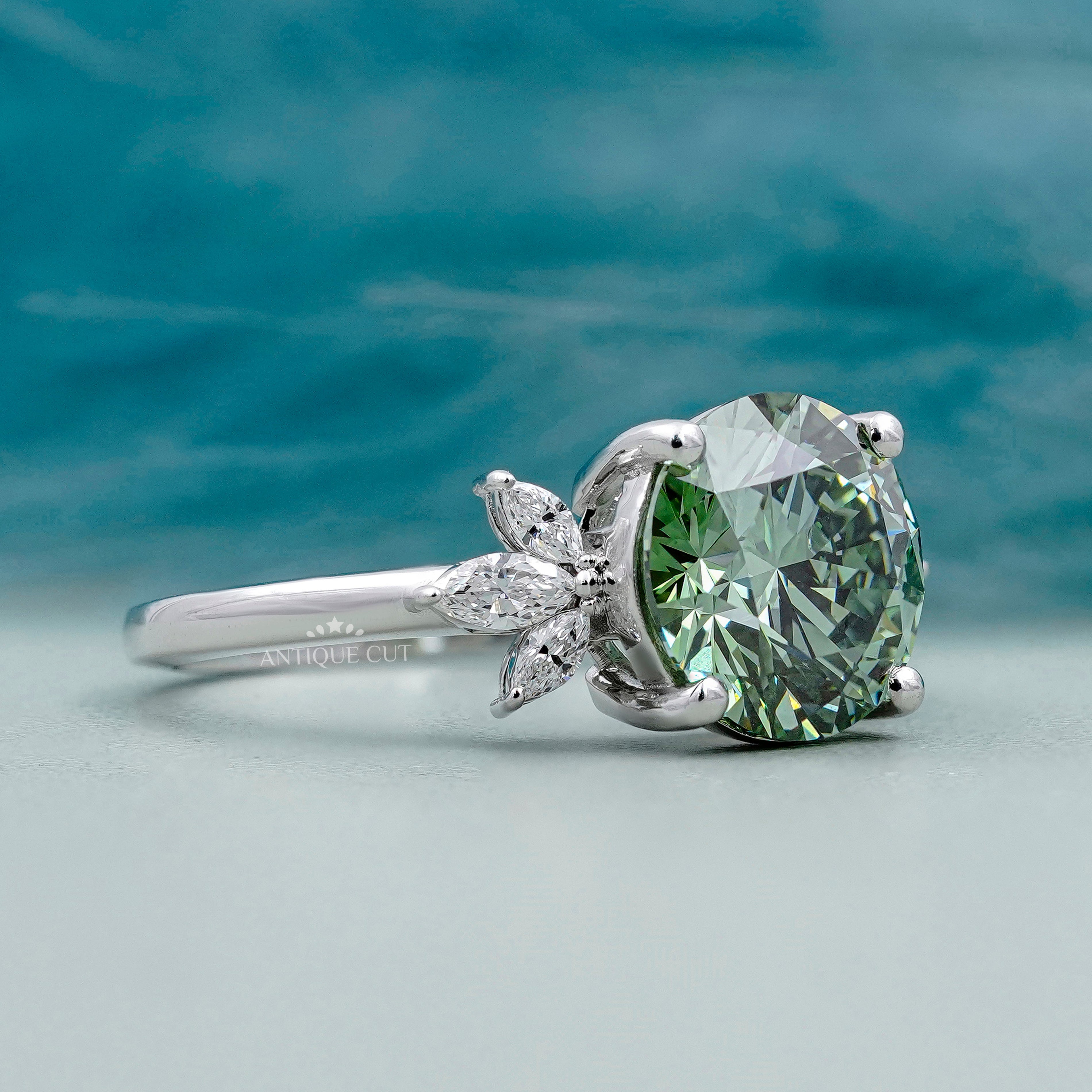 Antique green diamond ring with marquise diamond accents