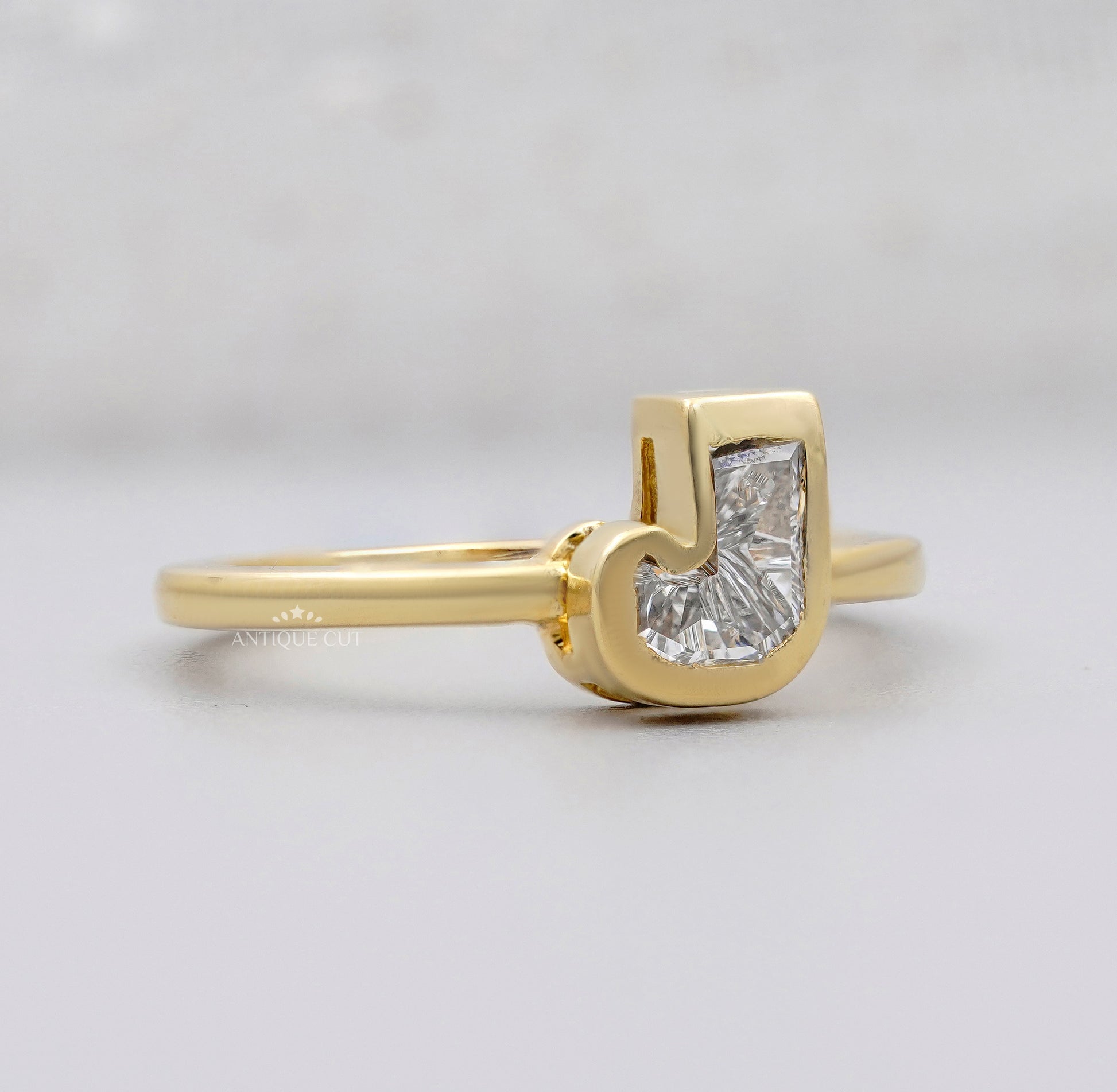 Yellow gold J initial ring with bezel set lab grown diamond and IGI certification