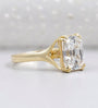Elongated radiant diamond solitaire ring with yellow gold band
