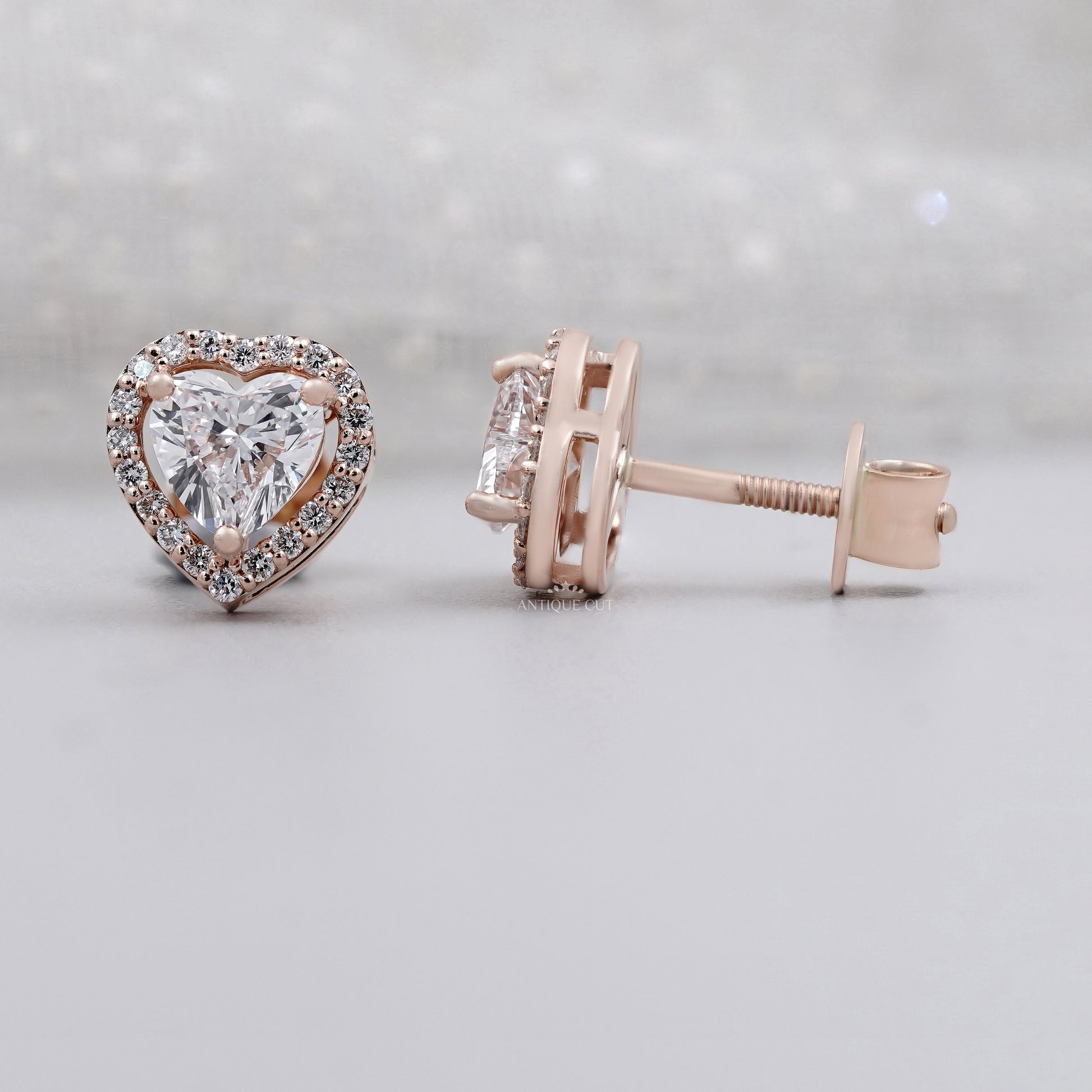 Rose gold halo diamond stud earrings with heart cut center