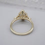 Oval center diamond with side stones and hidden halo