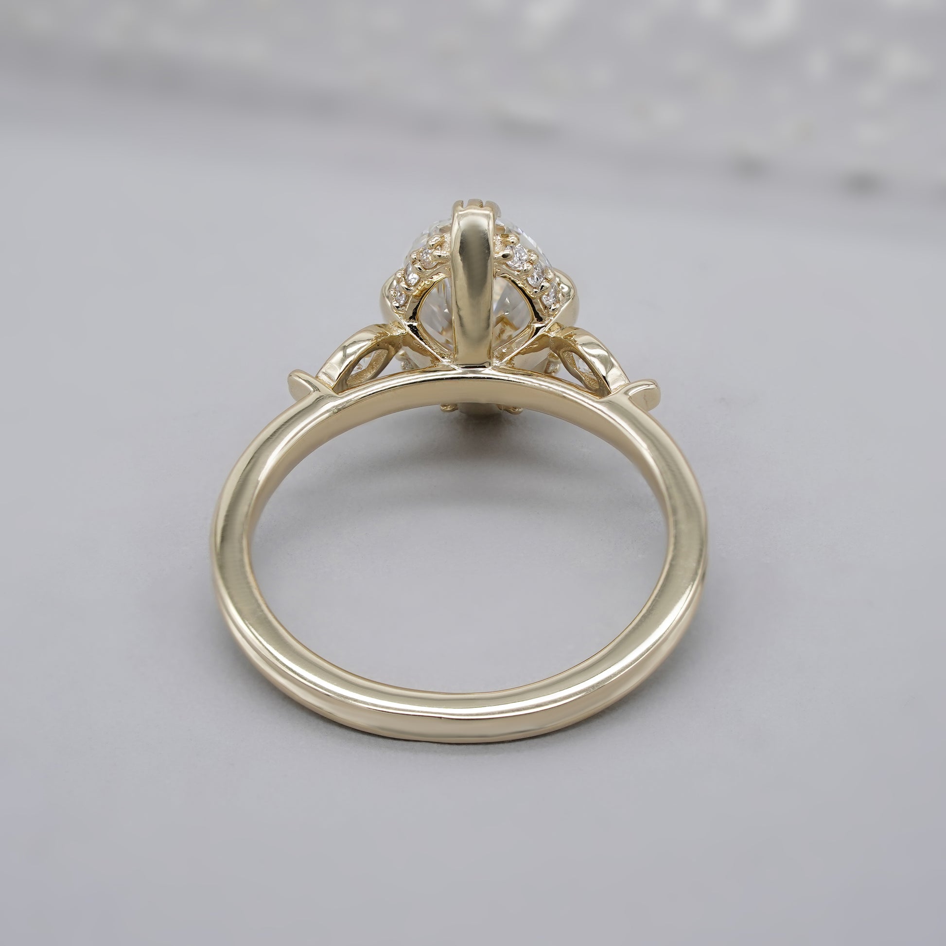 Oval center diamond with side stones and hidden halo