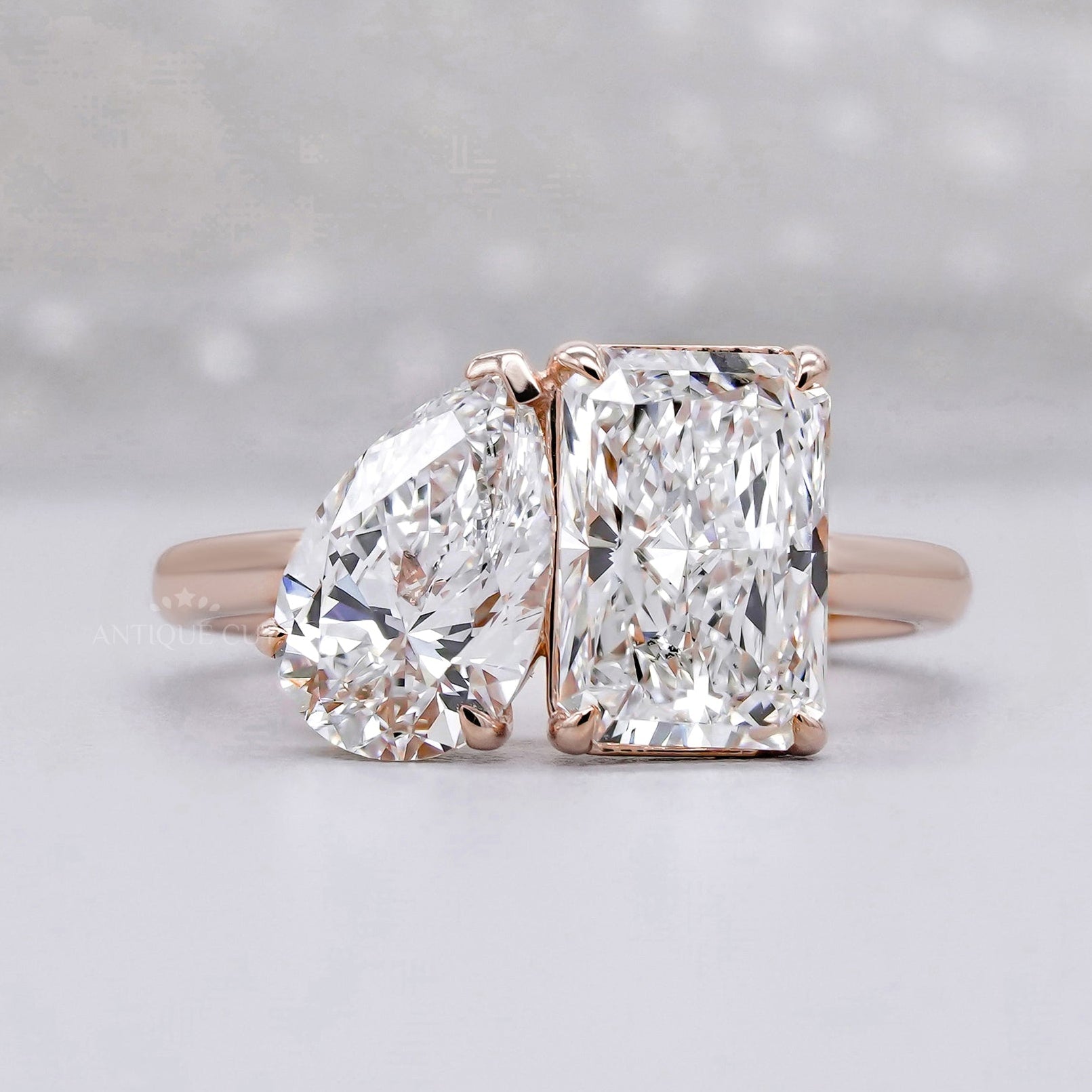 Two tone pear and radiant diamond ring in rose gold