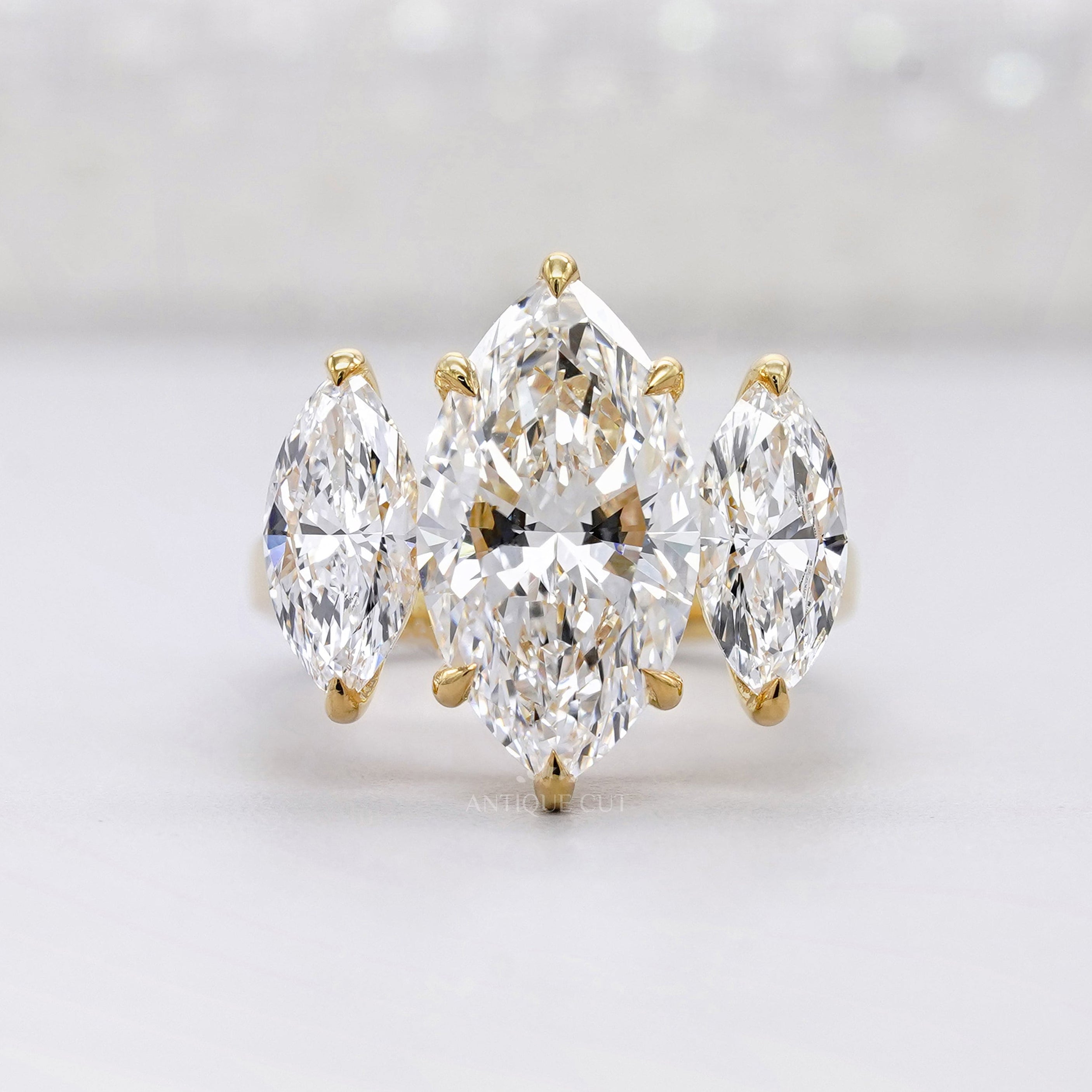 Three stone marquise engagement ring in yellow gold