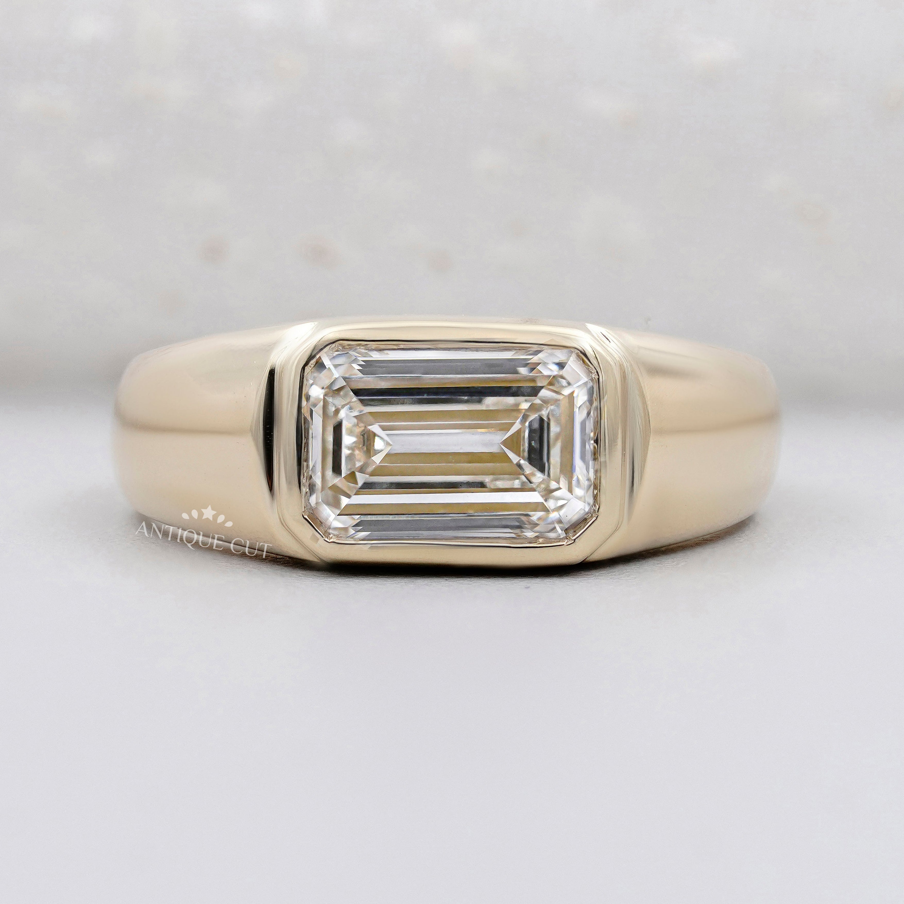 emerald cut engagement ring bezel set yellow gold