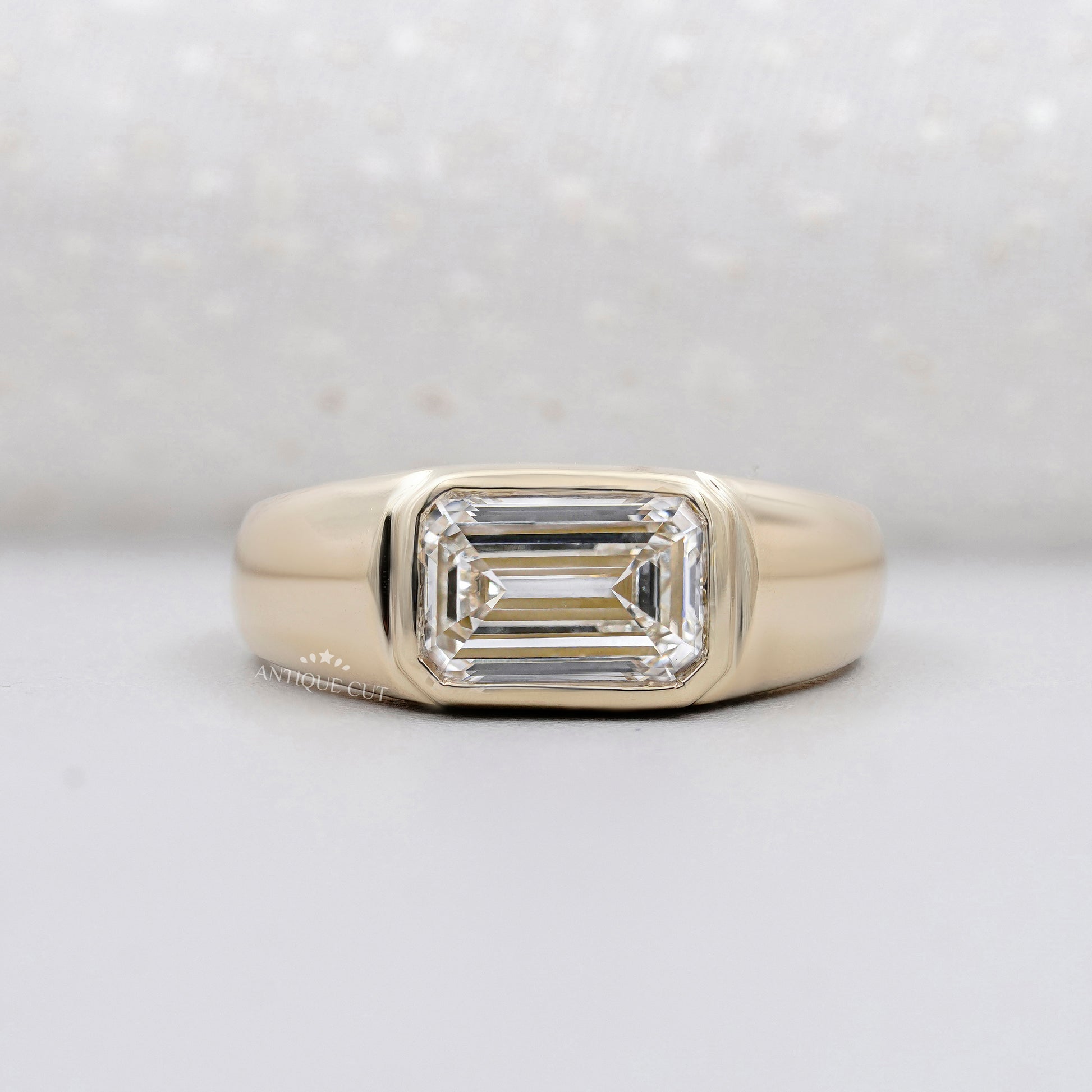 emerald cut engagement ring bezel set yellow gold